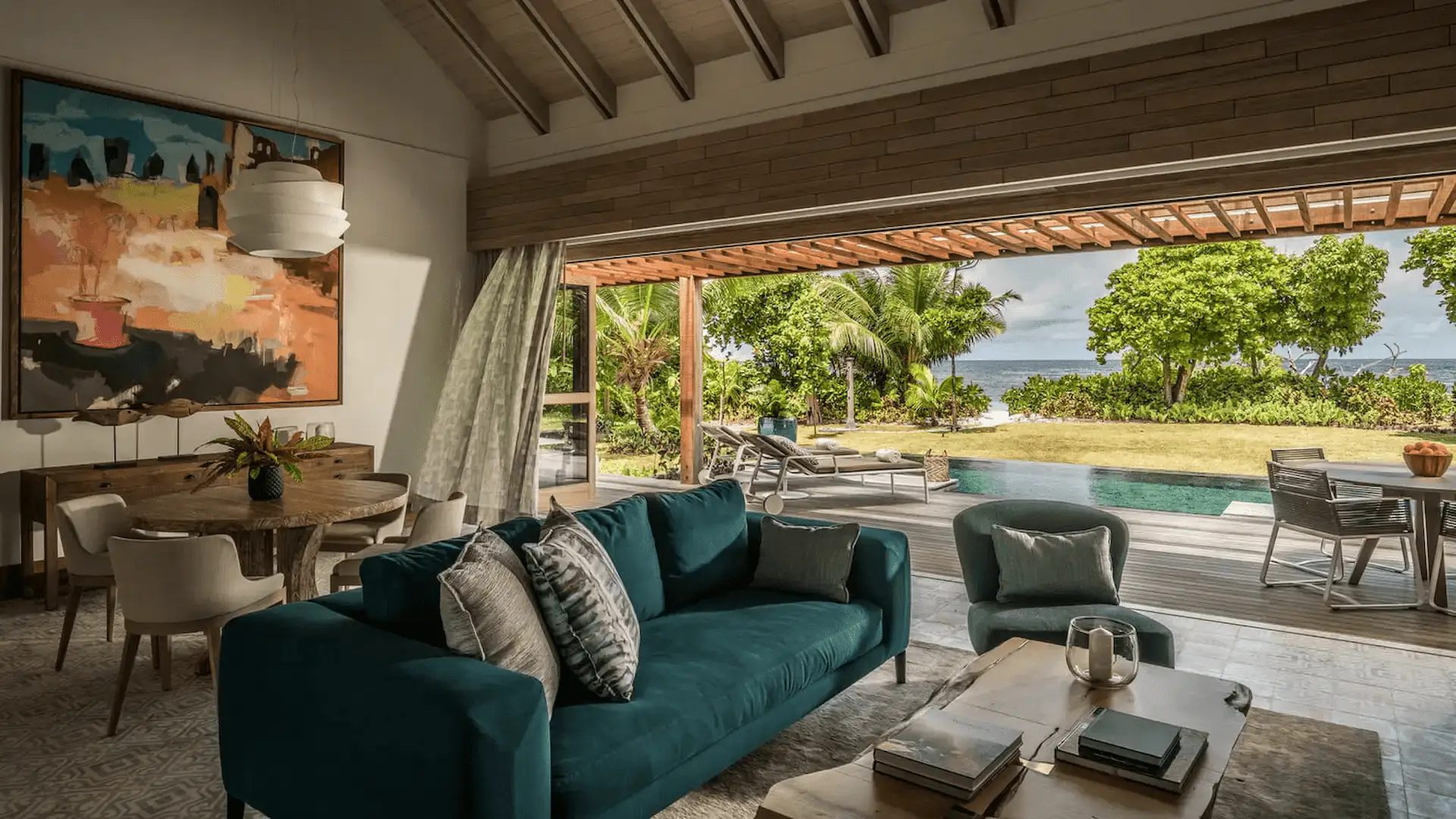 "terrace view of a two bedroom presidential villa at four seasons resort desroches seychelles overlooking the ocean and pool area