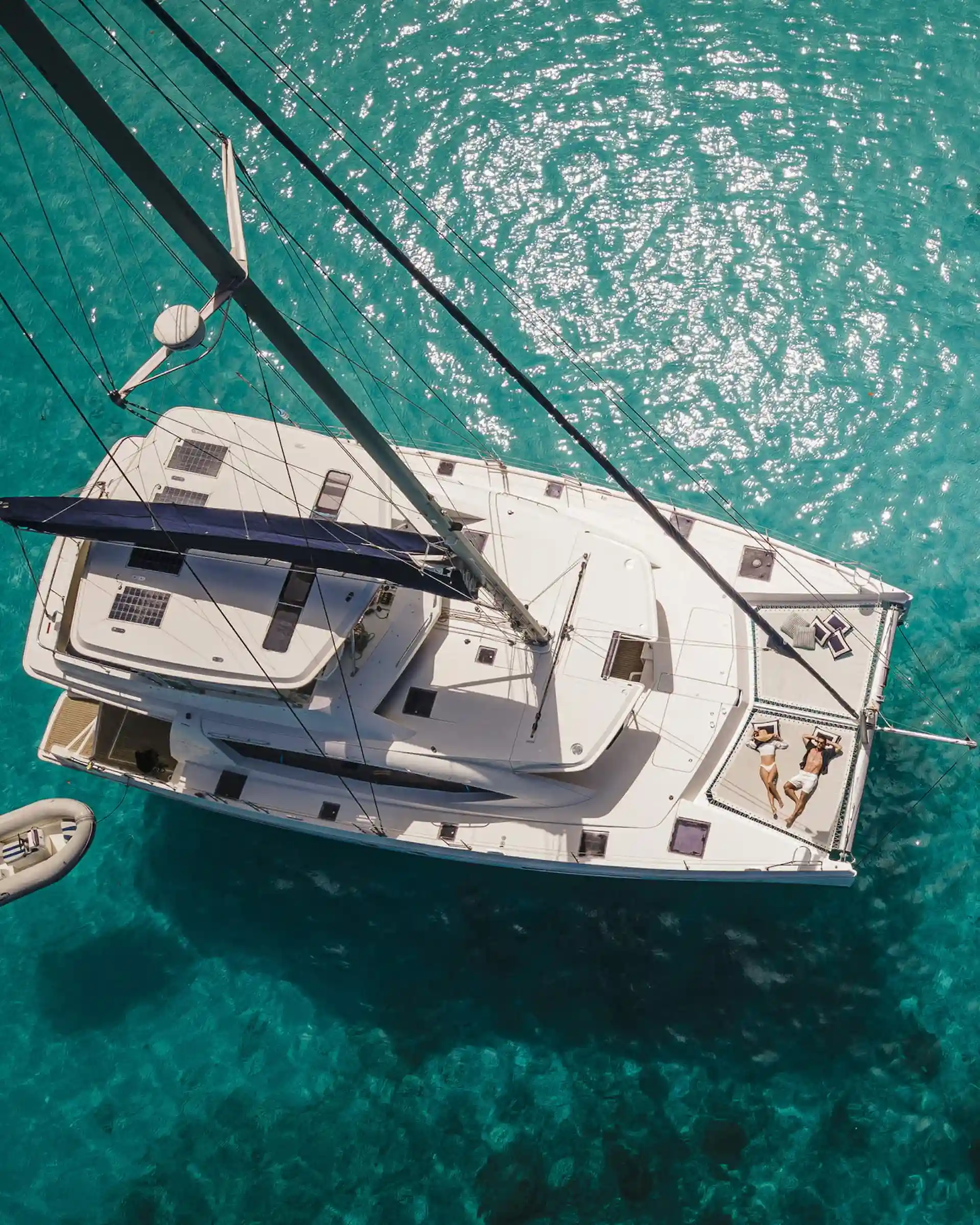 boat trip from Four Seasons Resort Seychelles with guests on a boat sailing across clear turquoise waters near the tropical coastline