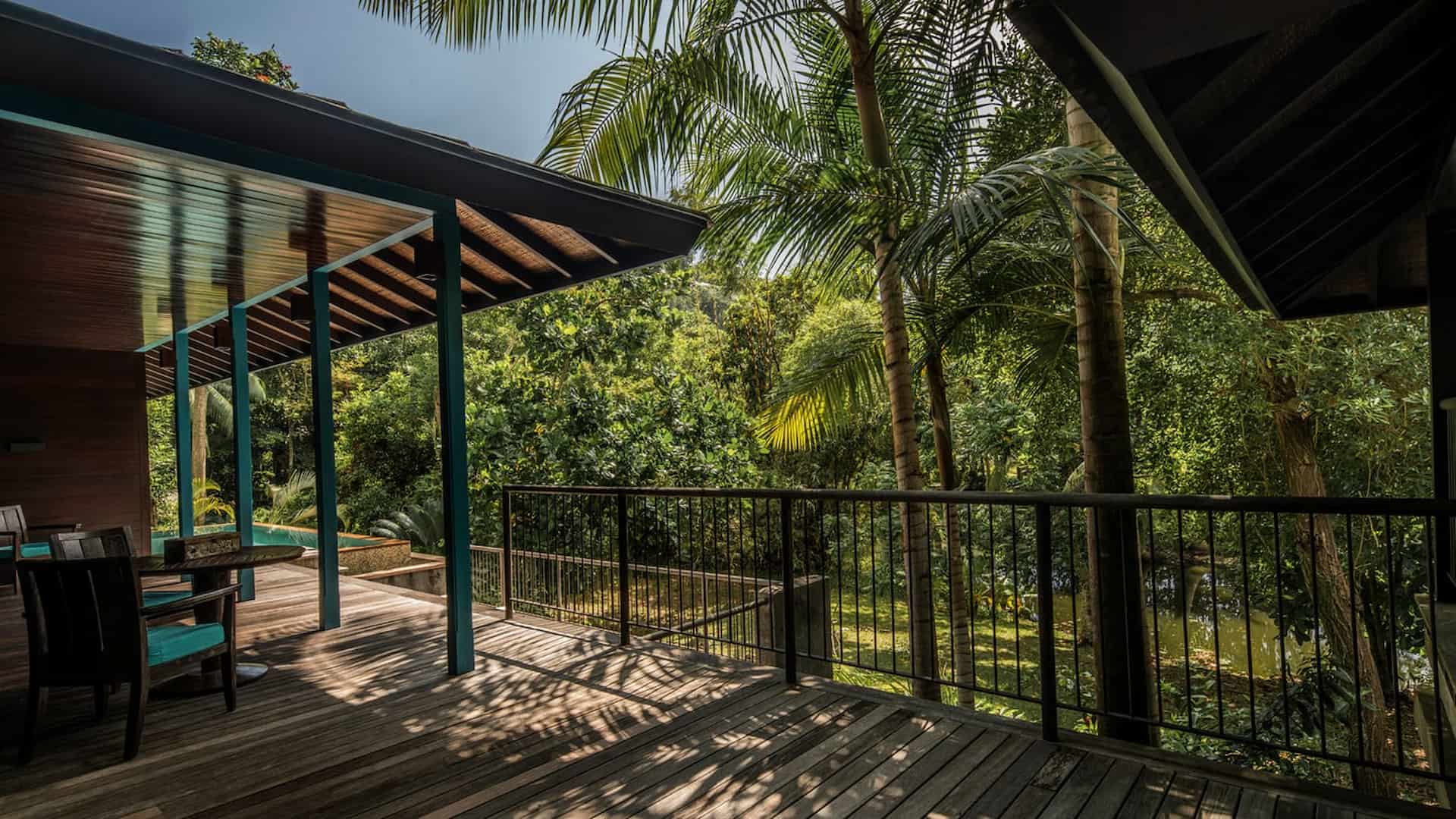 decking area of a garden view villa at Four Seasons Resort Seychelles surrounded by tropical greenery with seating space