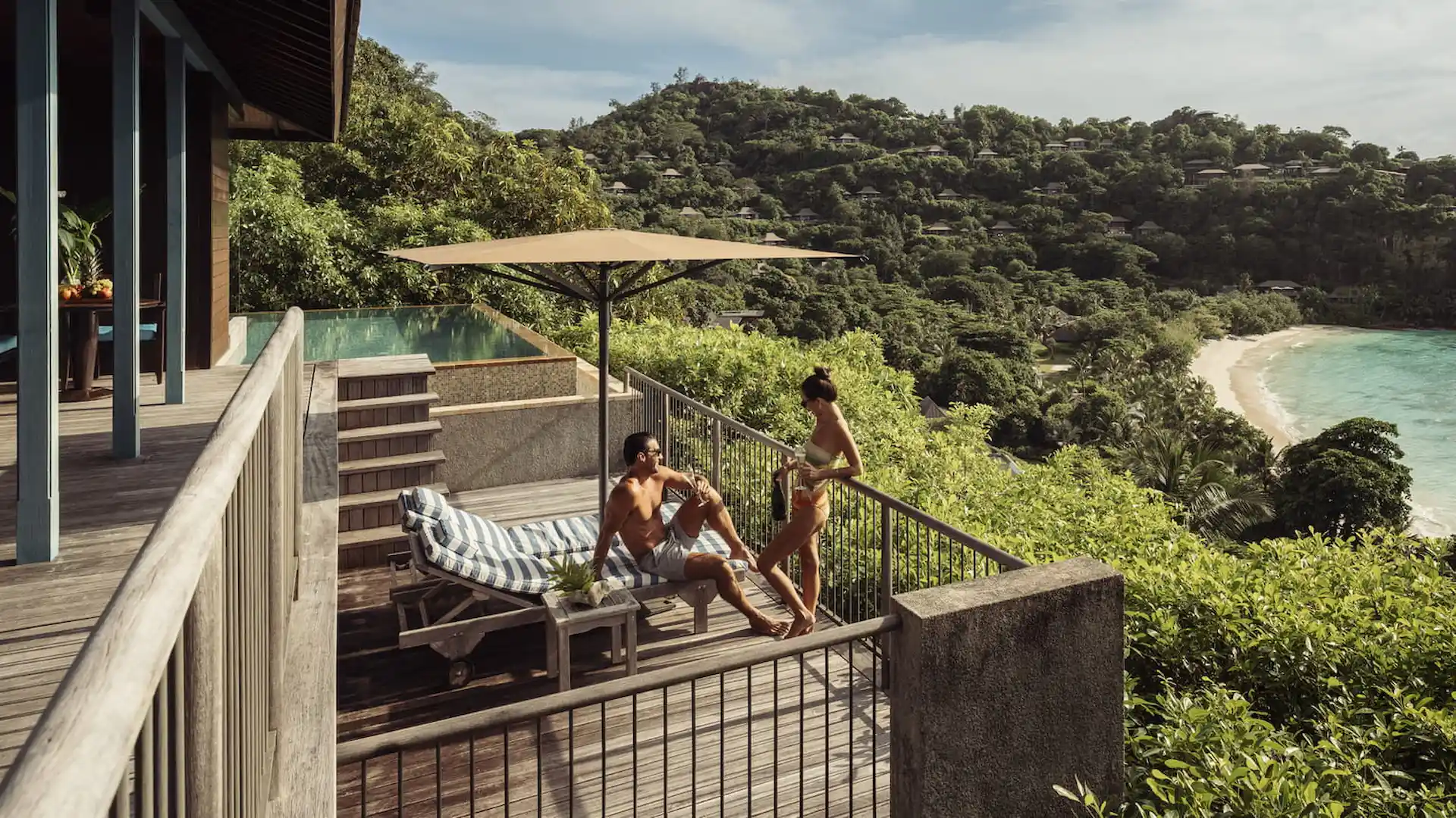 balcony of a hillside ocean view villa at Four Seasons Resort Seychelles overlooking tropical forest and the ocean horizon