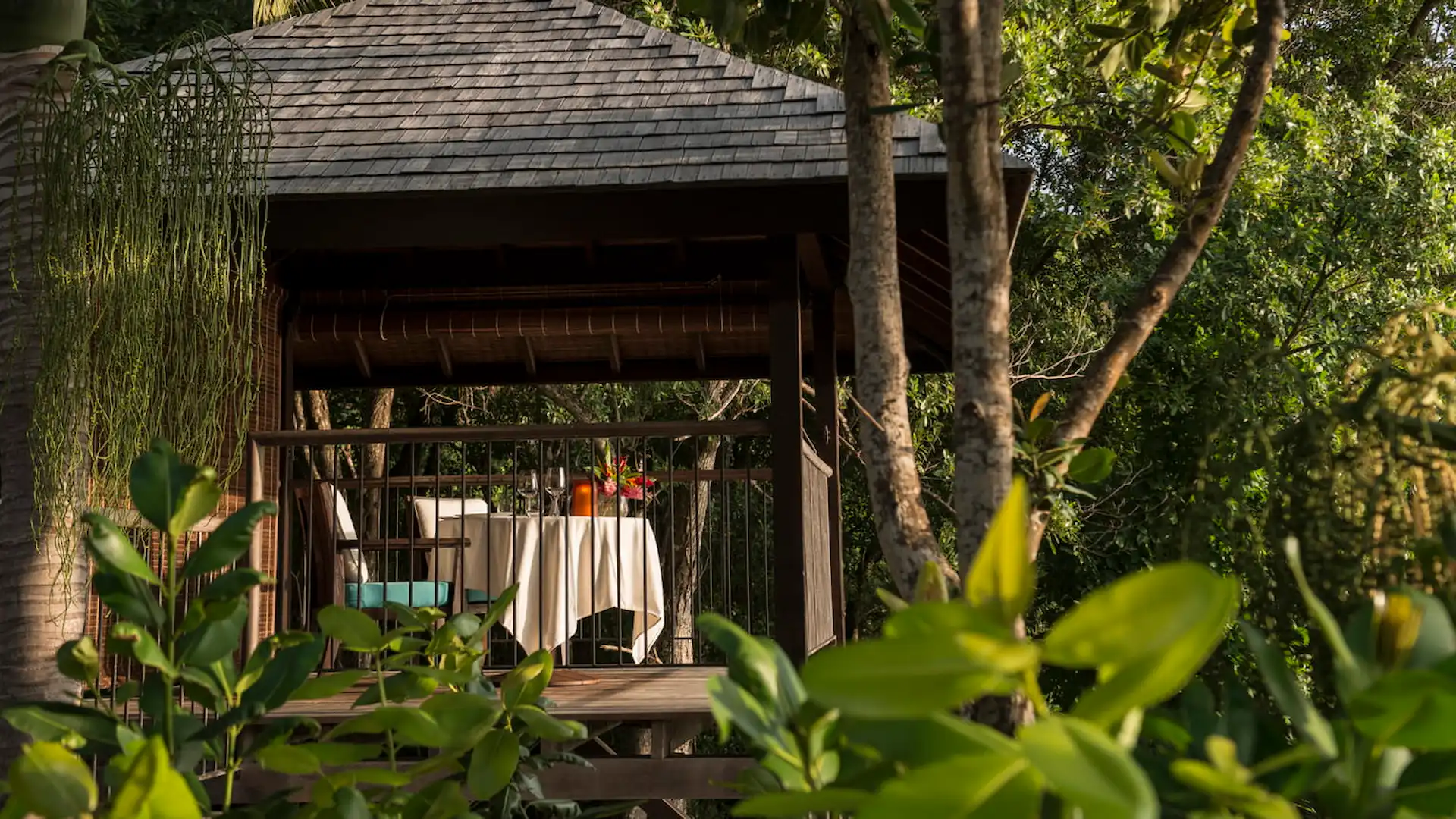 balcony of a serenity villa at Four Seasons Resort Seychelles overlooking tropical greenery and the ocean horizon