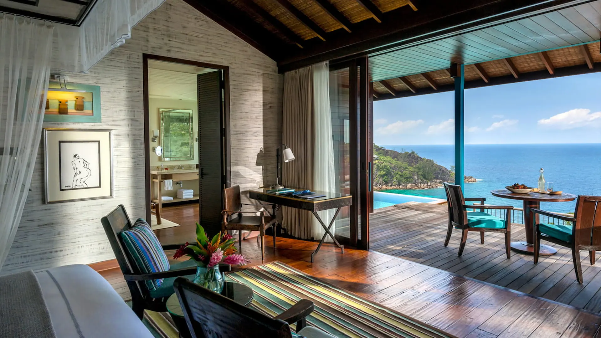 bedroom view from a serenity villa at Four Seasons Resort Seychelles with large bed and views of tropical surroundings and ocean