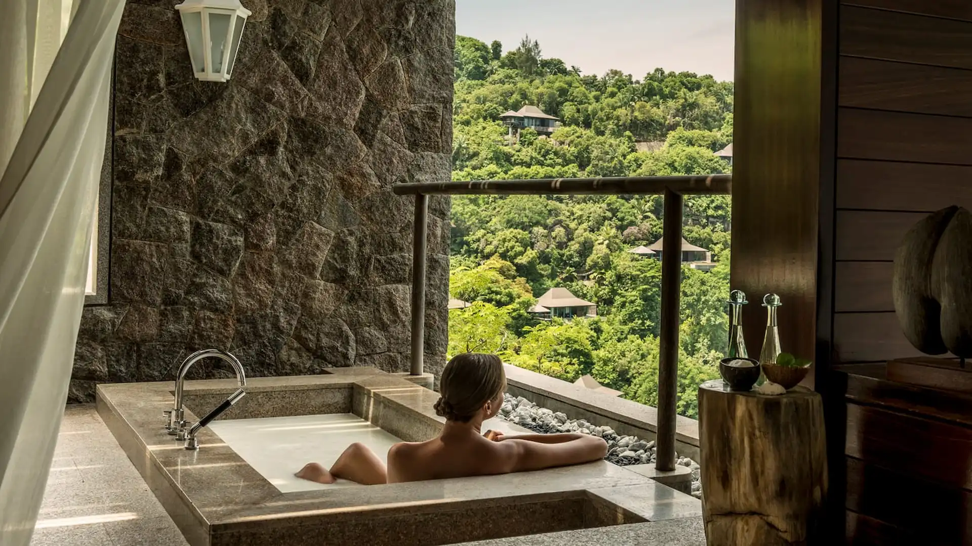 spa at Four Seasons Resort Seychelles set in a tropical setting with open air treatment spaces and lush greenery