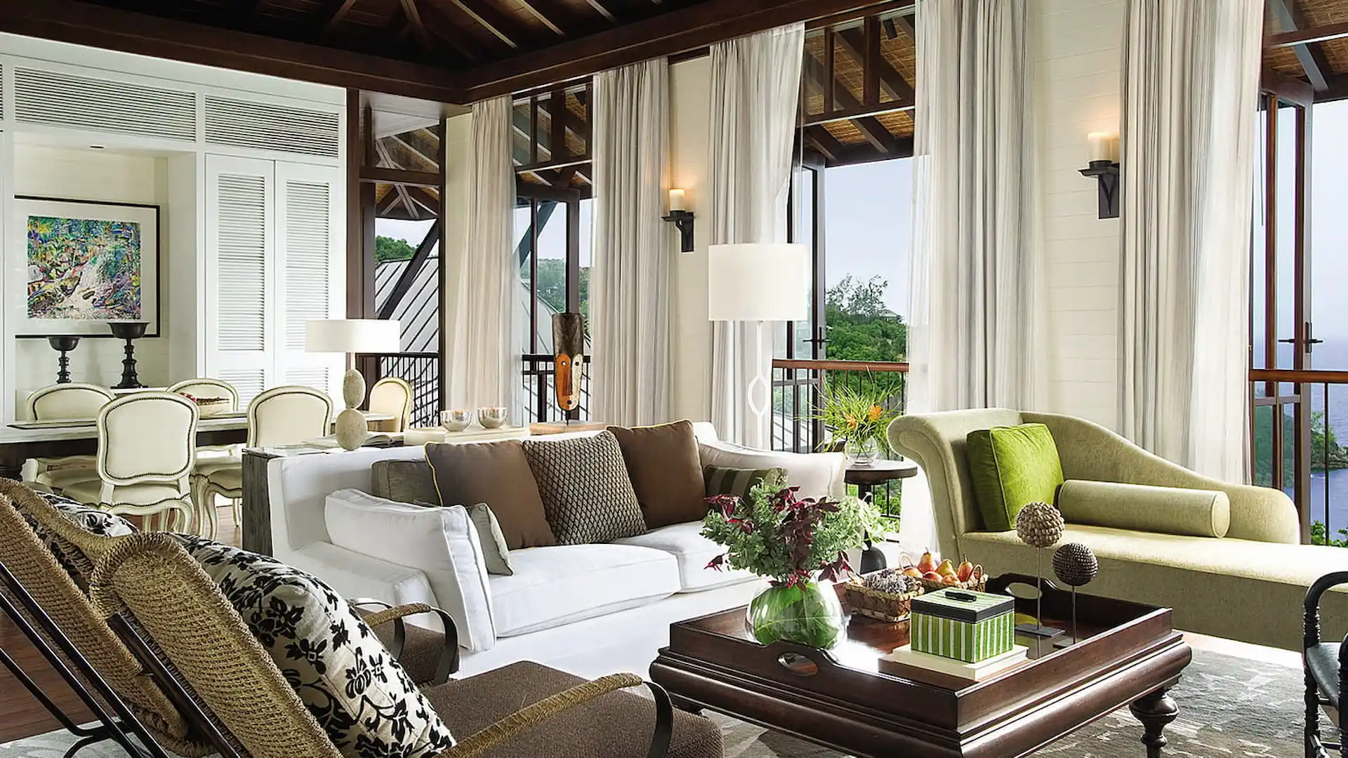 aerial view of the lounge area in a two bedroom ocean view villa at Four Seasons Resort Seychelles surrounded by tropical greenery and overlooking the ocean