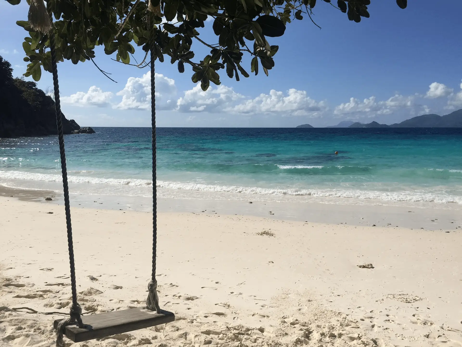 beach swing at Four Seasons Resort Seychelles overlooking white sand and turquoise ocean waters