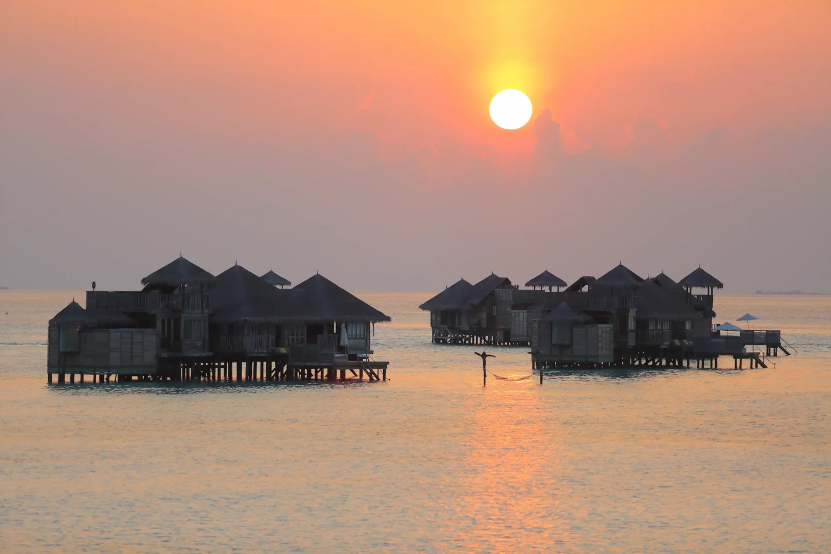 a peaceful crusoe residence at sunset at gili lankanfushi maldives overlooking soft golden lagoon light
