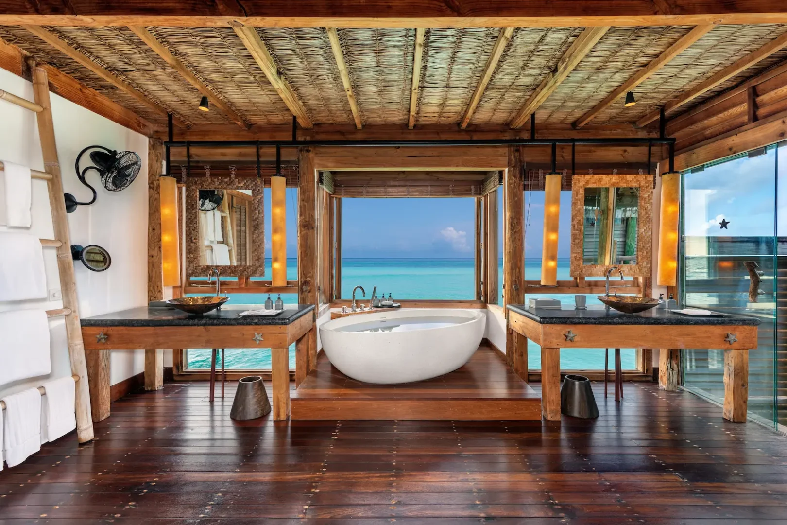 a serene crusoe residence bathroom at gili lankanfushi maldives featuring natural materials and calming overwater ambience