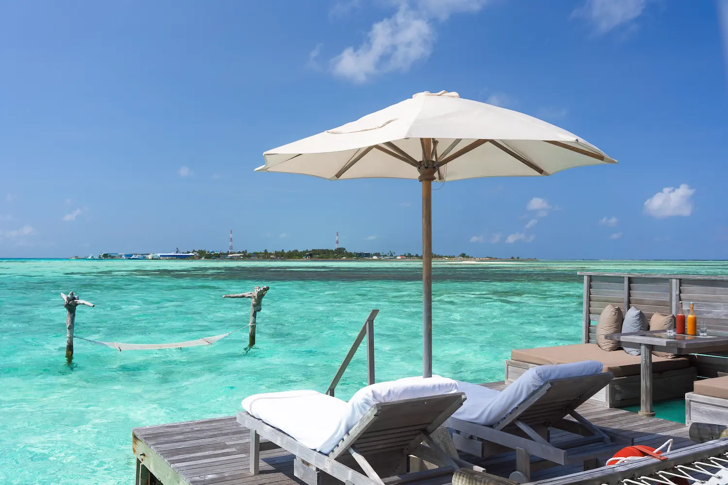 a peaceful crusoe residence island view at gili lankanfushi maldives overlooking the calm lagoon and lush shoreline