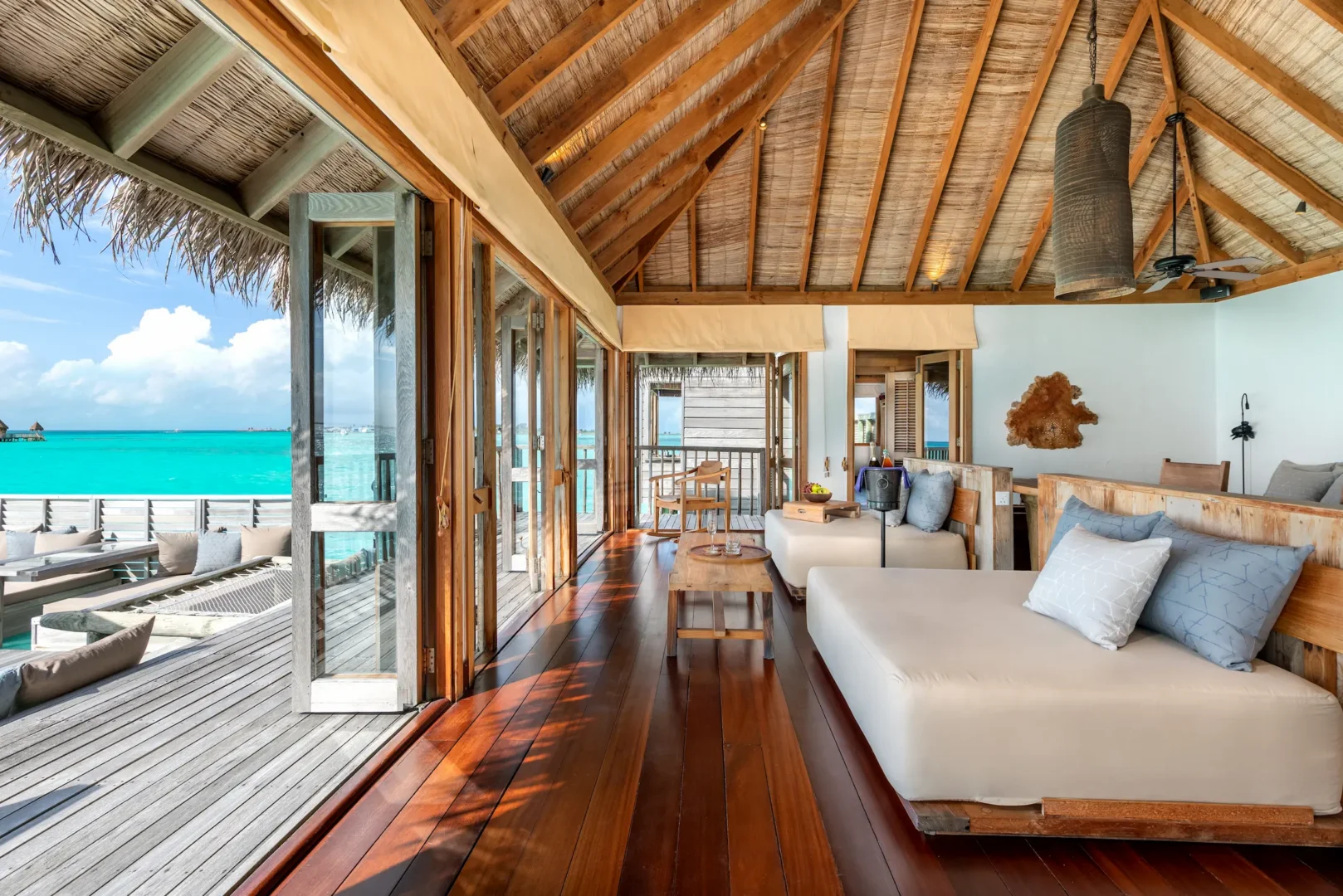 a spacious crusoe residence living area at gili lankanfushi maldives featuring natural materials and calming lagoon views