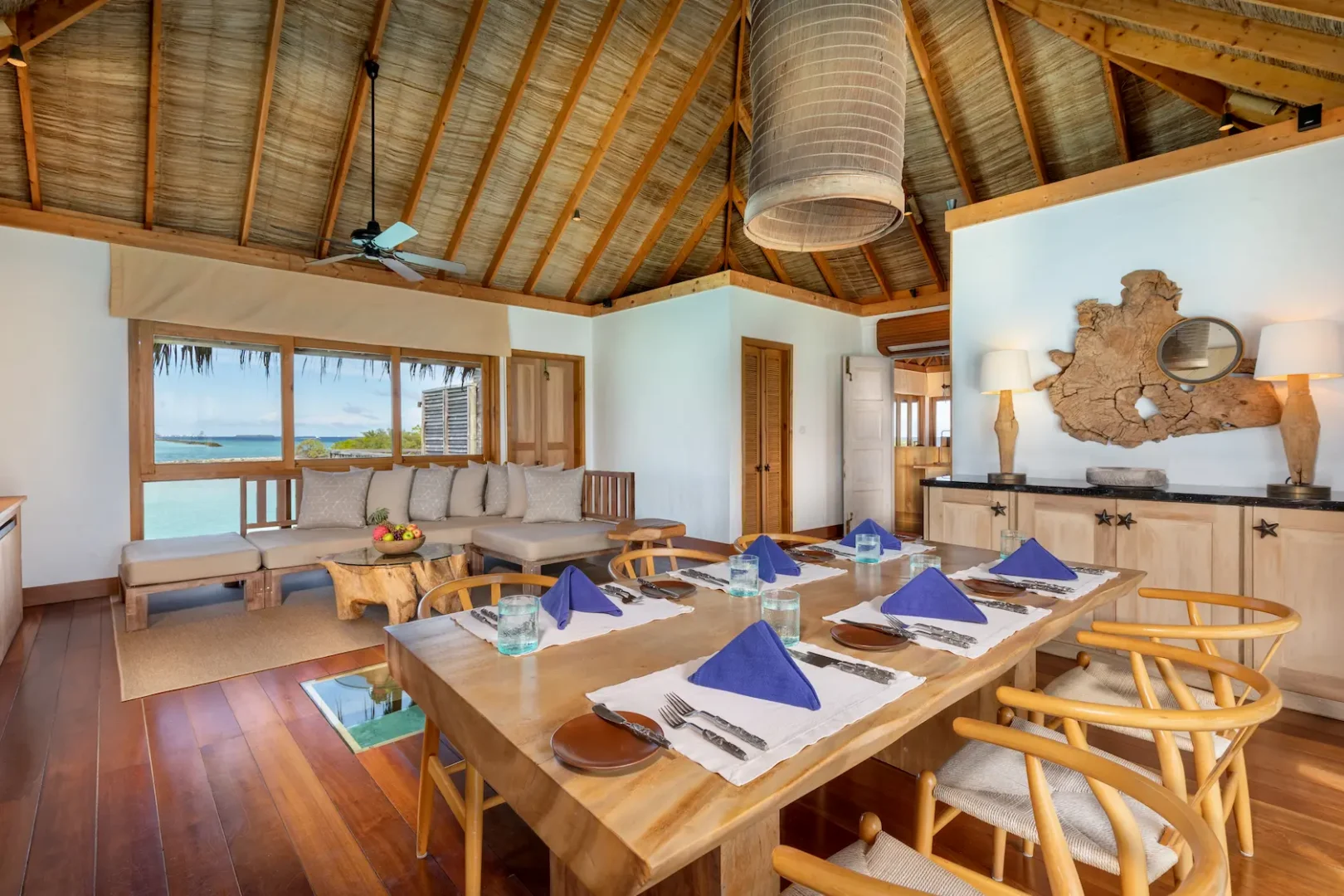 a spacious family villa living dining area at gili lankanfushi maldives featuring natural textures and open lagoon views
