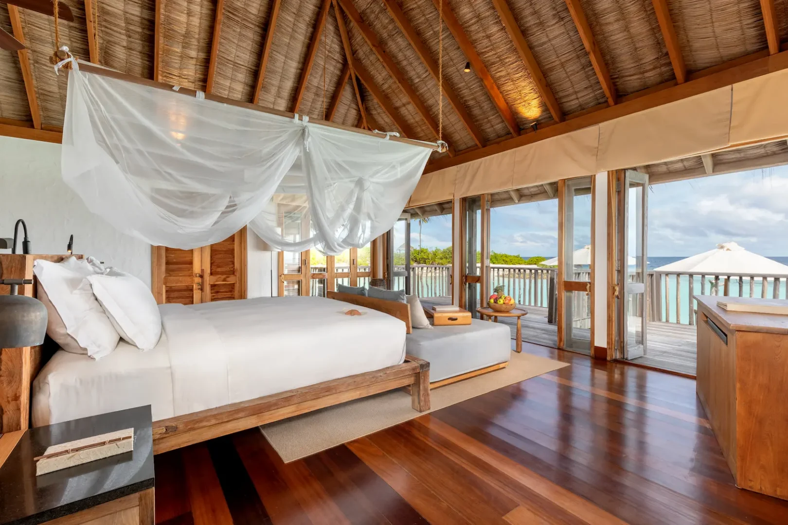 a calming family villa master bedroom at gili lankanfushi maldives featuring soft natural materials and gentle lagoon views