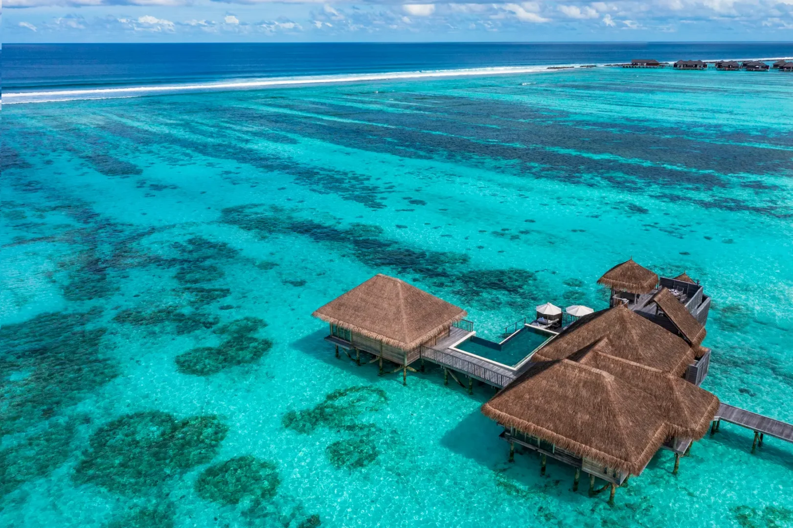 an elevated family villa with pool aerial exterior view at gili lankanfushi maldives capturing its serene overwater setting