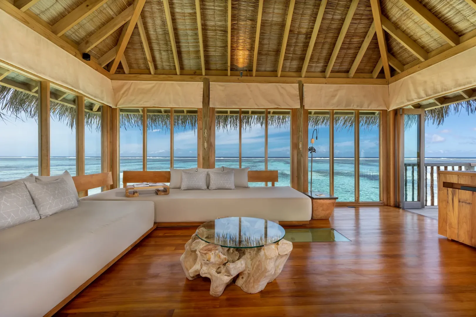 a bright family villa with pool living area at gili lankanfushi maldives featuring natural textures and open lagoon views