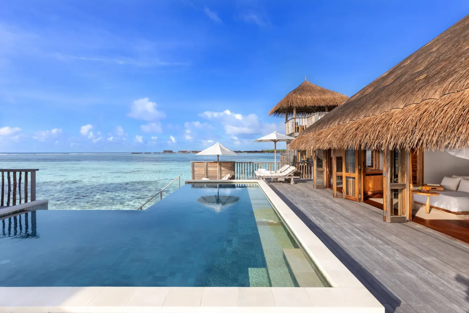 a relaxing family villa with pool pool and deck at gili lankanfushi maldives overlooking calm turquoise lagoon waters