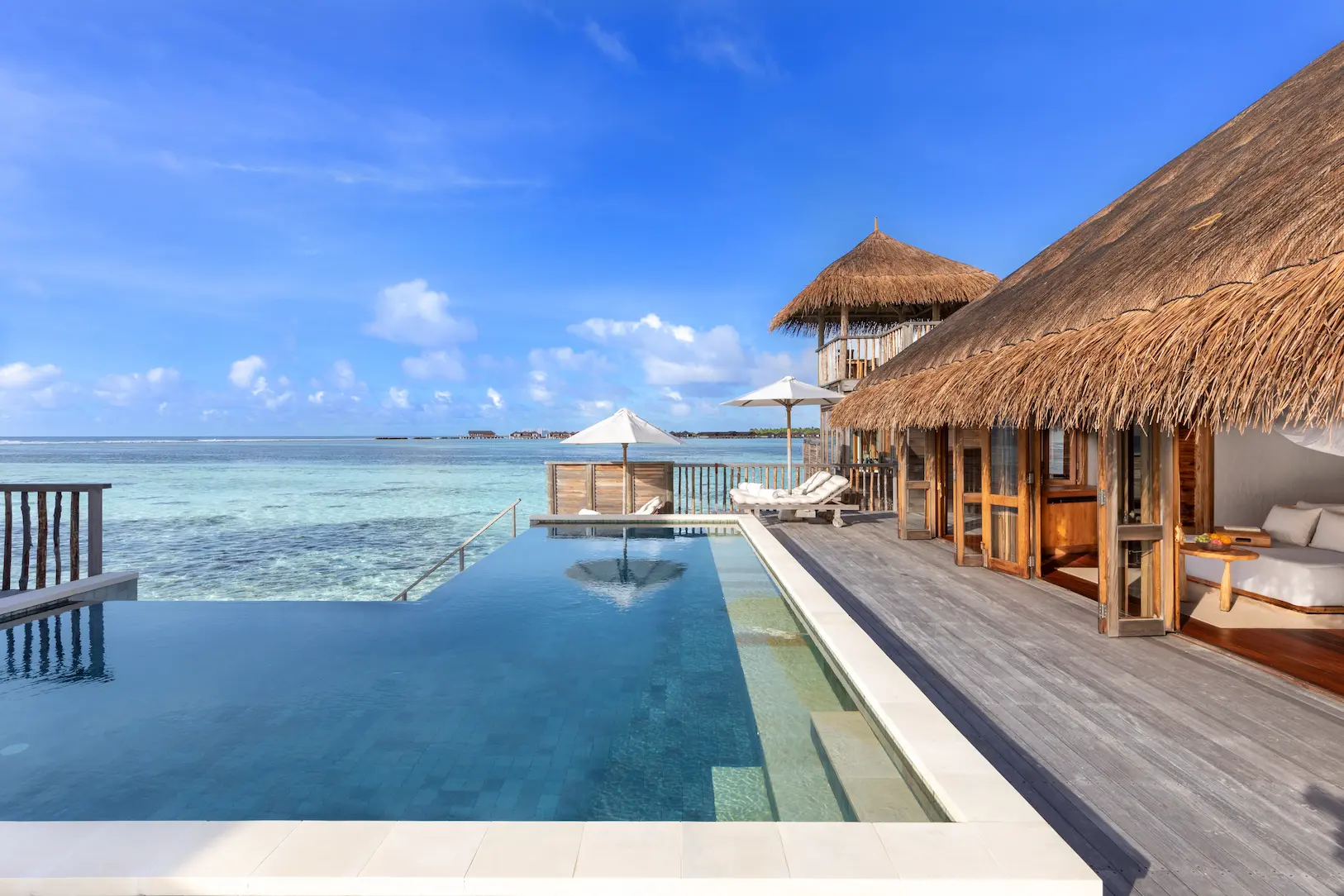 a relaxing family villa with pool pool and deck at gili lankanfushi maldives overlooking calm turquoise lagoon waters