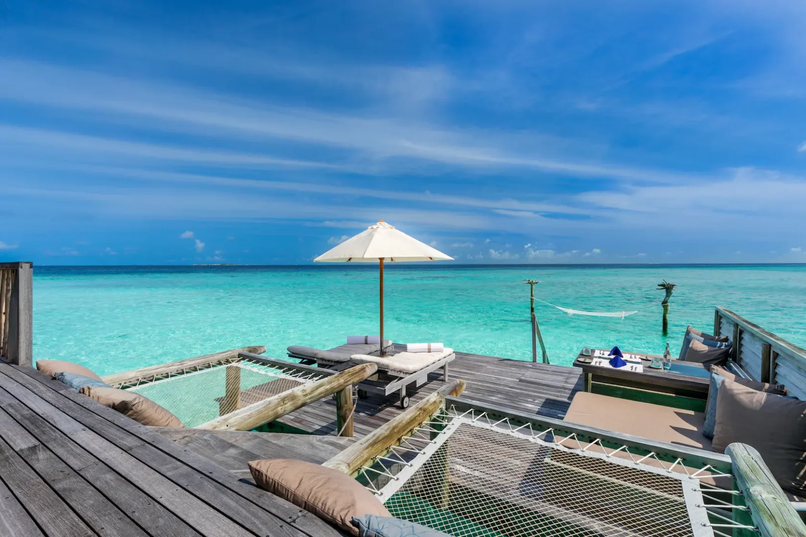 a spacious gili lagoon residence deck at gili lankanfushi maldives overlooking calm turquoise lagoon waters