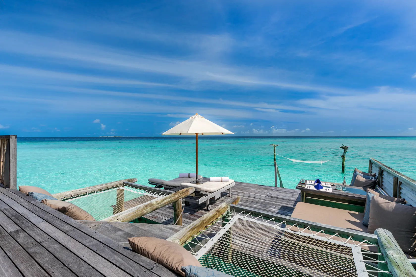 a spacious gili lagoon residence deck at gili lankanfushi maldives overlooking calm turquoise lagoon waters