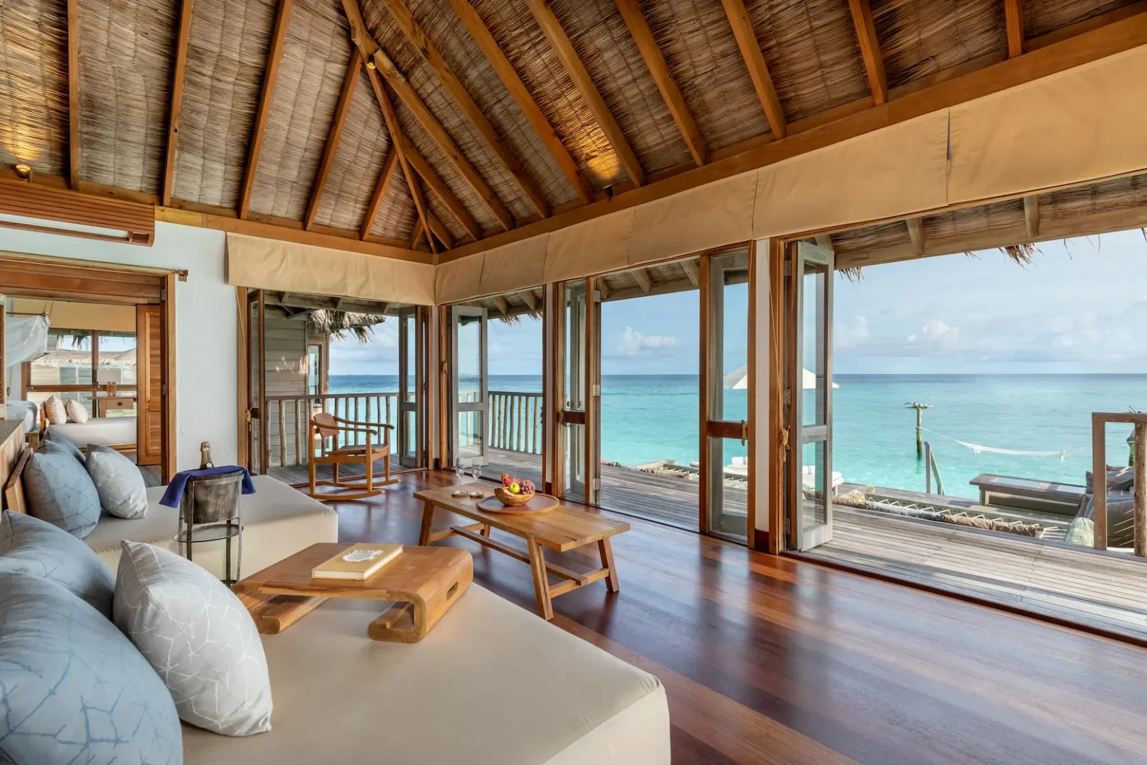 a spacious gili lagoon residence living area at gili lankanfushi maldives featuring natural materials and open lagoon views