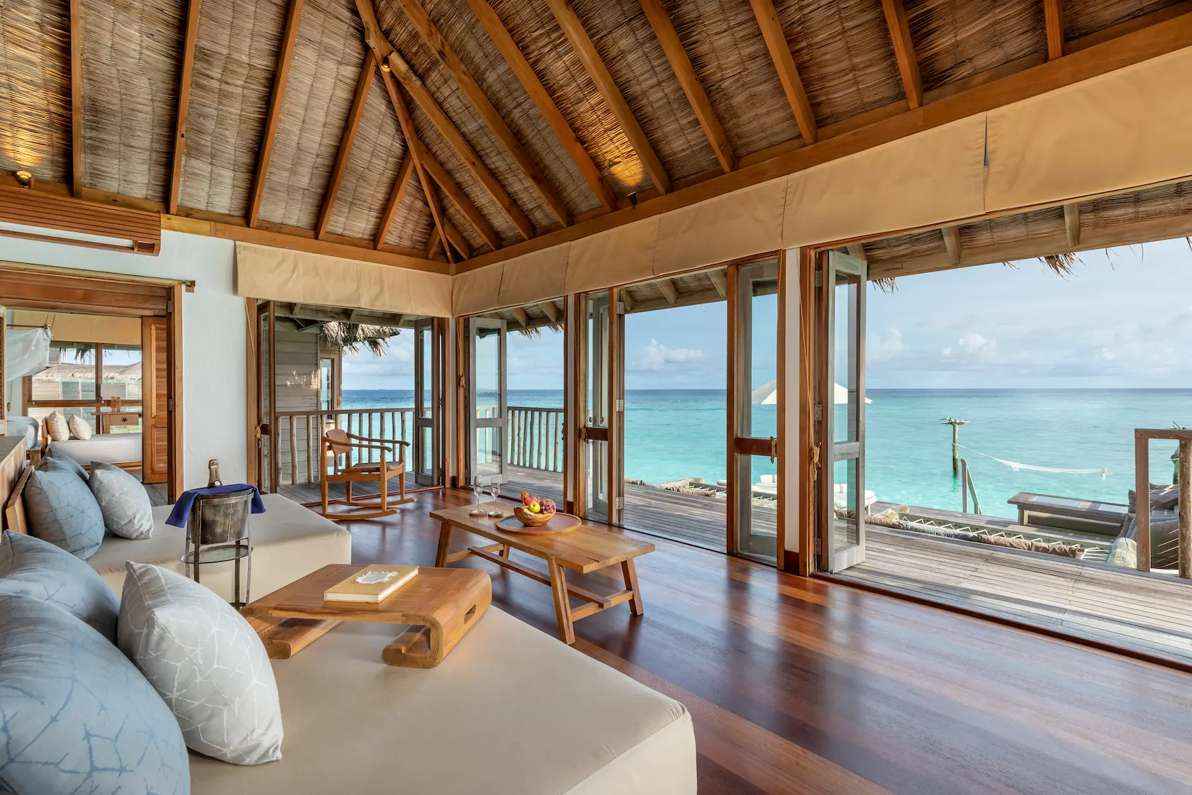 a spacious gili lagoon residence living area at gili lankanfushi maldives featuring natural materials and open lagoon views