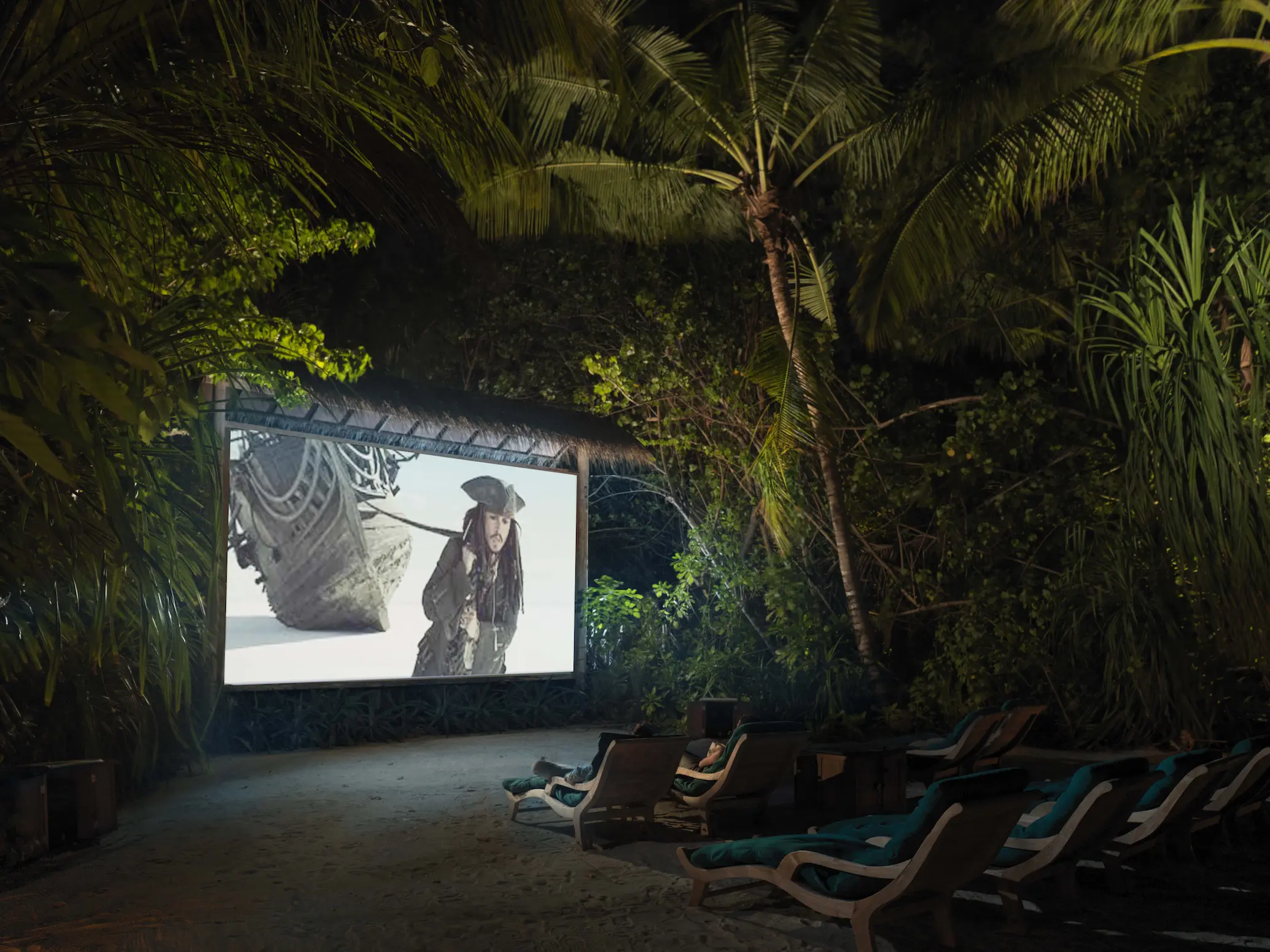 a cosy movie nights at jungle cinema experience at gili lankanfushi maldives set within lush tropical greenery
