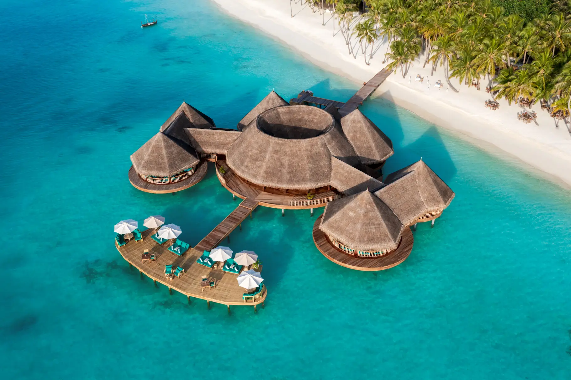 an elegant overwater bar aerial scene at gili lankanfushi maldives overlooking calm turquoise lagoon waters