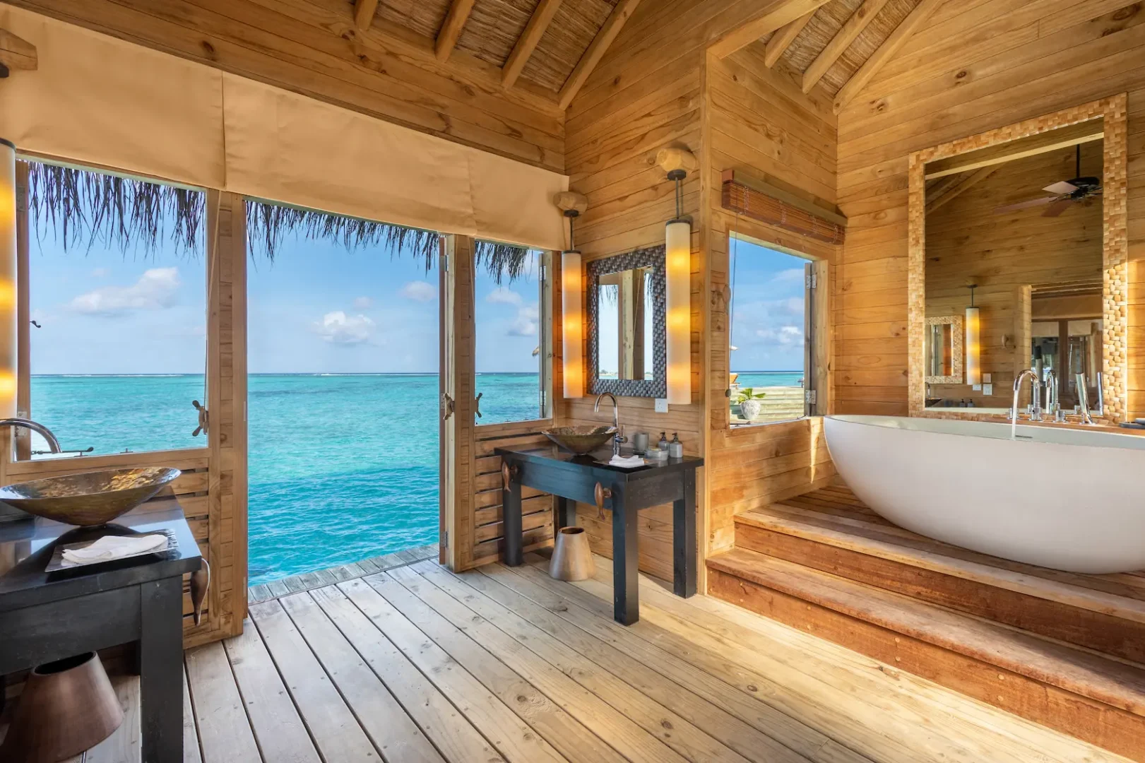 a tranquil private reserve bedroom with view at gili lankanfushi maldives overlooking soft turquoise lagoon views