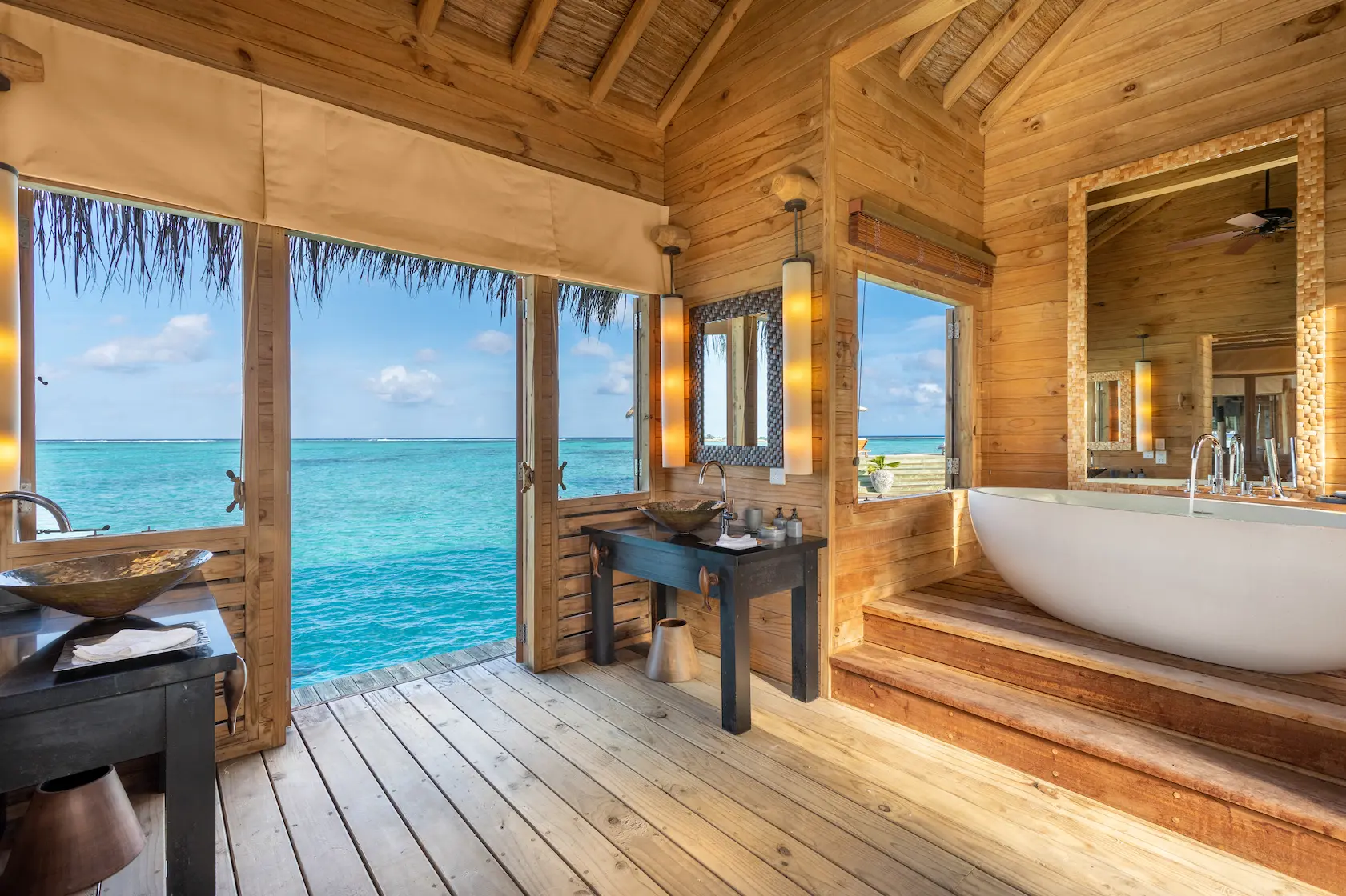 a tranquil private reserve bedroom with view at gili lankanfushi maldives overlooking soft turquoise lagoon views