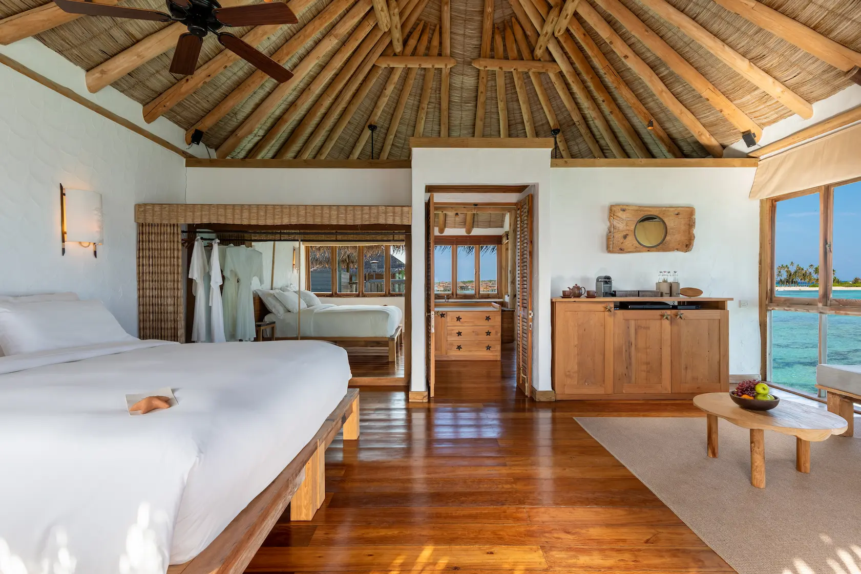 a serene private reserve guest bedroom at gili lankanfushi maldives featuring soft natural textures and calming lagoon views