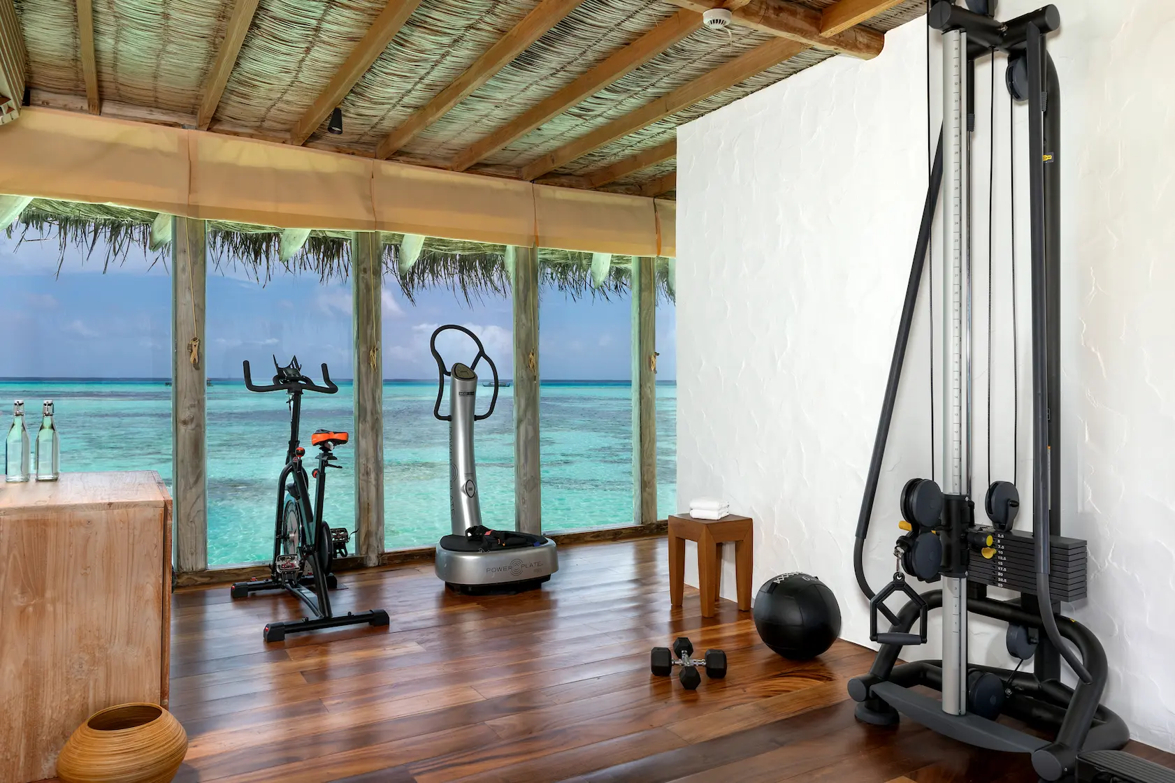 a bright private reserve gym at gili lankanfushi maldives featuring natural materials and calming lagoon views