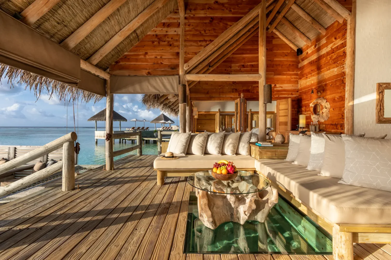 a relaxing private reserve living room outdoor space at gili lankanfushi maldives overlooking the calm turquoise lagoon