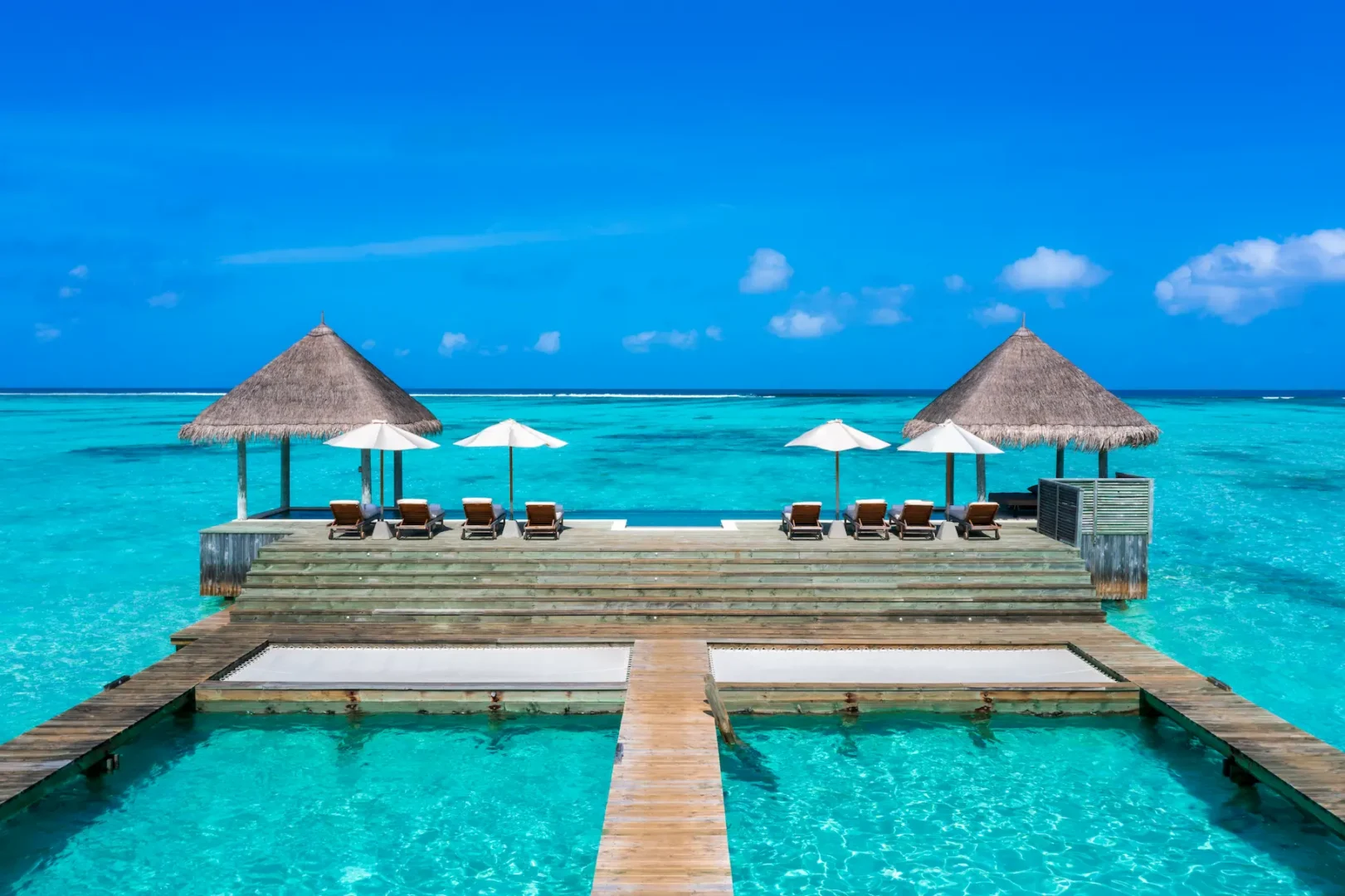 a spacious private reserve main outdoor deck at gili lankanfushi maldives overlooking calm turquoise lagoon waters