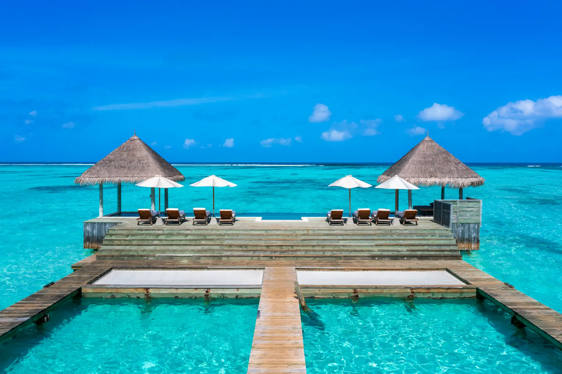 a spacious private reserve main outdoor deck at gili lankanfushi maldives overlooking calm turquoise lagoon waters