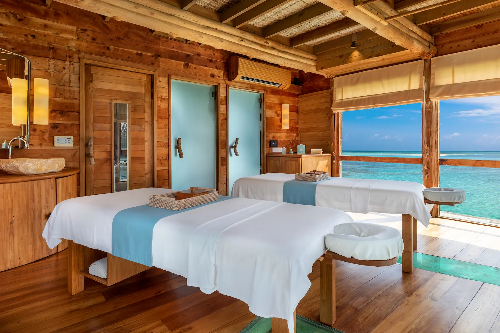 a calming private reserve spa room at gili lankanfushi maldives featuring natural materials and serene lagoon facing ambience