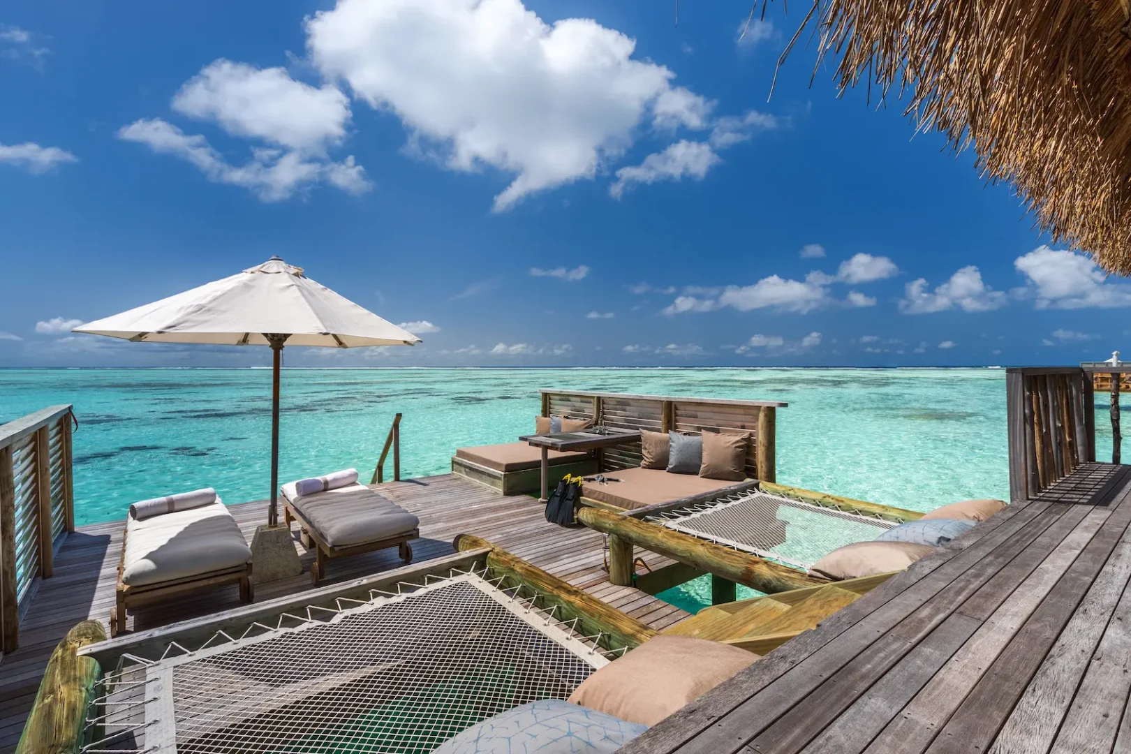 a spacious residence deck at gili lankanfushi maldives overlooking calm turquoise lagoon waters