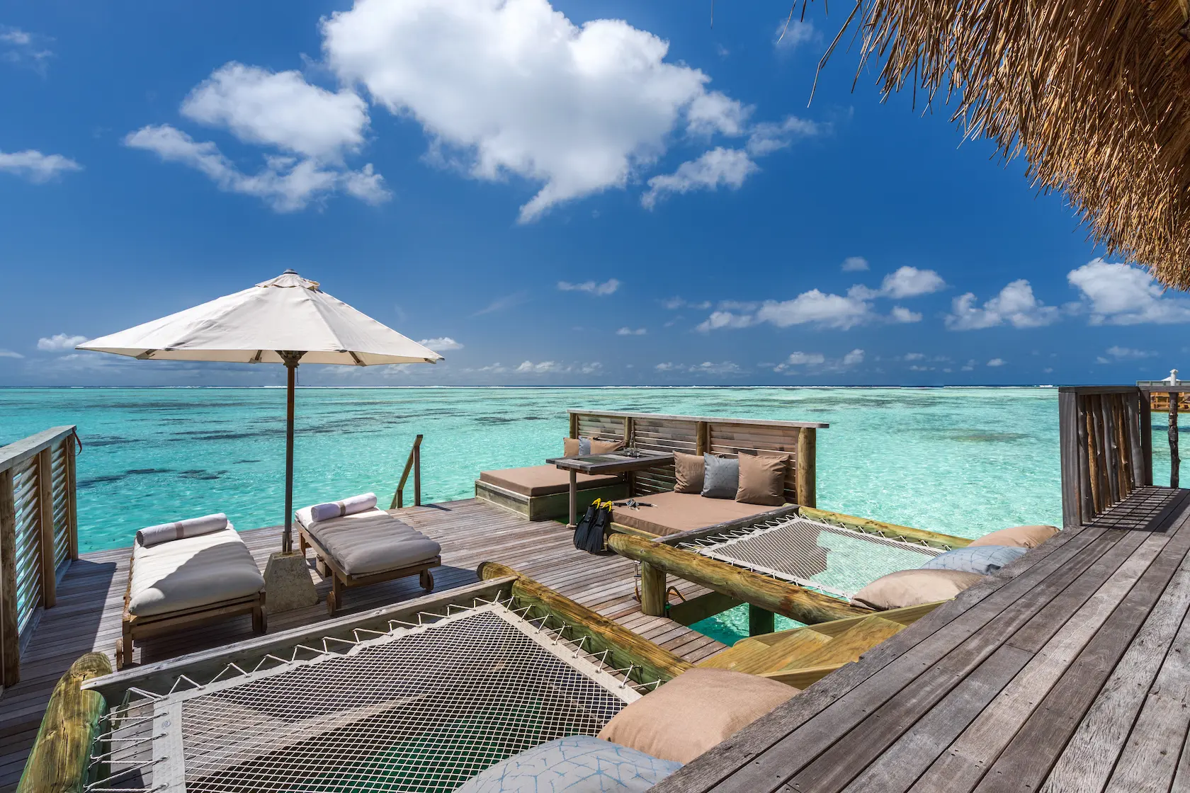a spacious residence deck at gili lankanfushi maldives overlooking calm turquoise lagoon waters