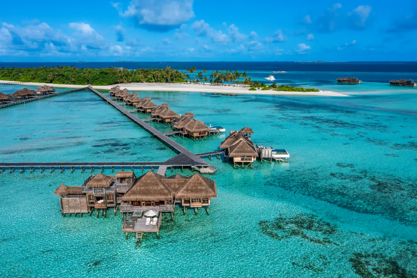 a residence jetty area at gili lankanfushi maldives overlooking clear calm lagoon waters