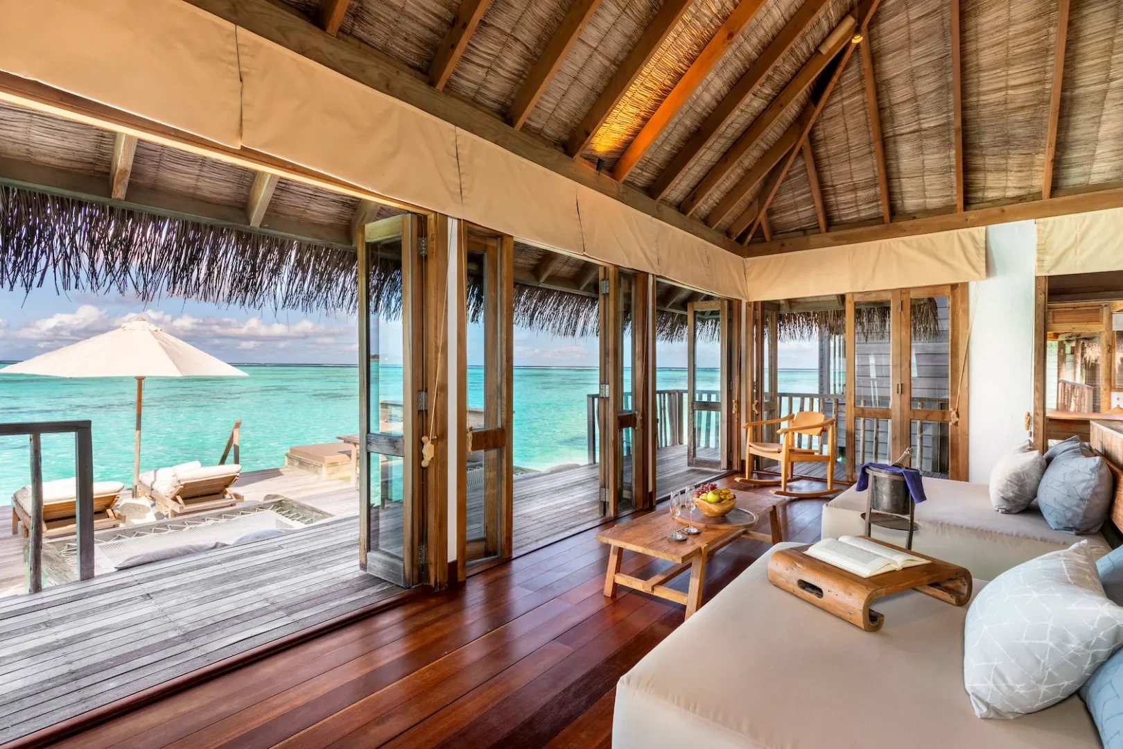 a spacious residence living area at gili lankanfushi maldives featuring natural materials and open lagoon views