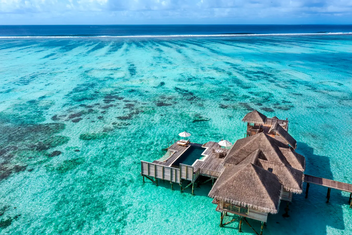 an elevated view of the residence with pool at gili lankanfushi maldives highlighting its expansive overwater setting