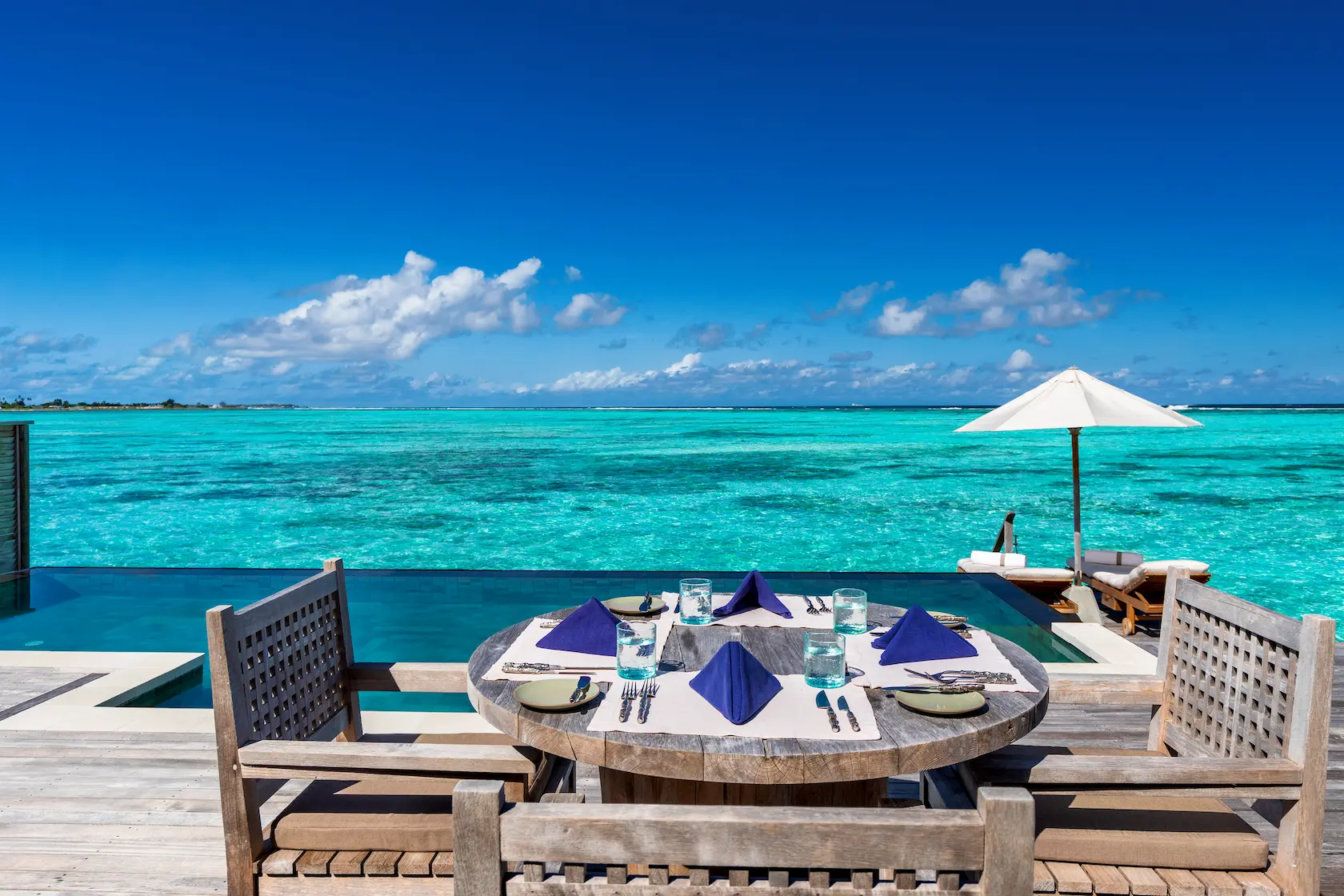 a serene residence with pool deck dining table at gili lankanfushi maldives overlooking calm turquoise lagoon waters