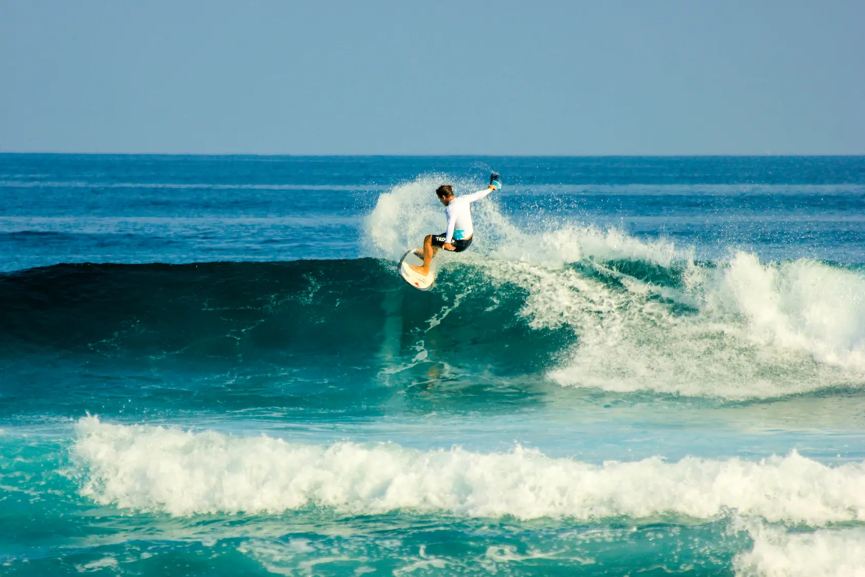 a dynamic surfing with tropicsurf moment at gili lankanfushi maldives riding gentle ocean swells