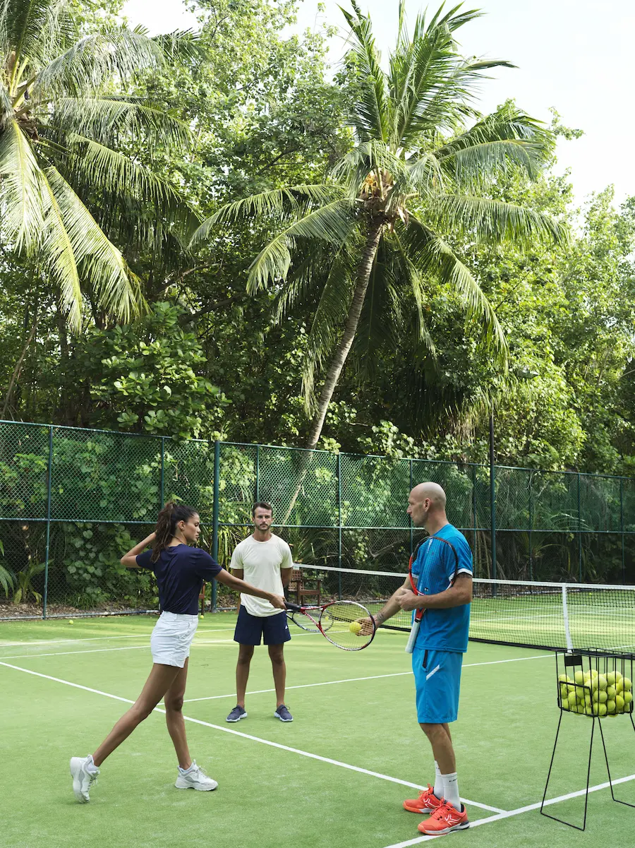 a dynamic tennis with a pro session at gili lankanfushi maldives set on a bright island court