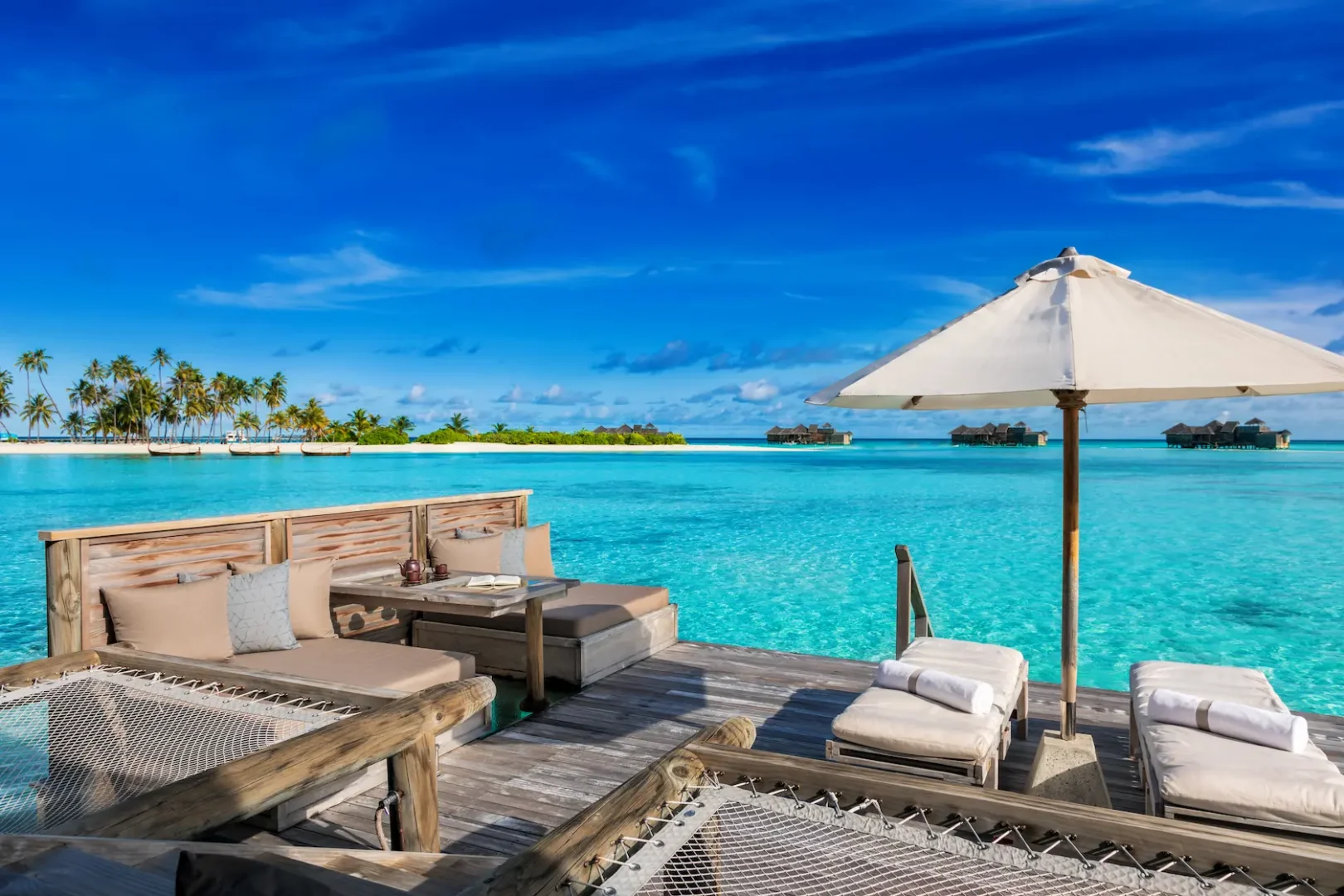 a peaceful overwater villa suite sun deck at gili lankanfushi maldives with open views across clear turquoise water