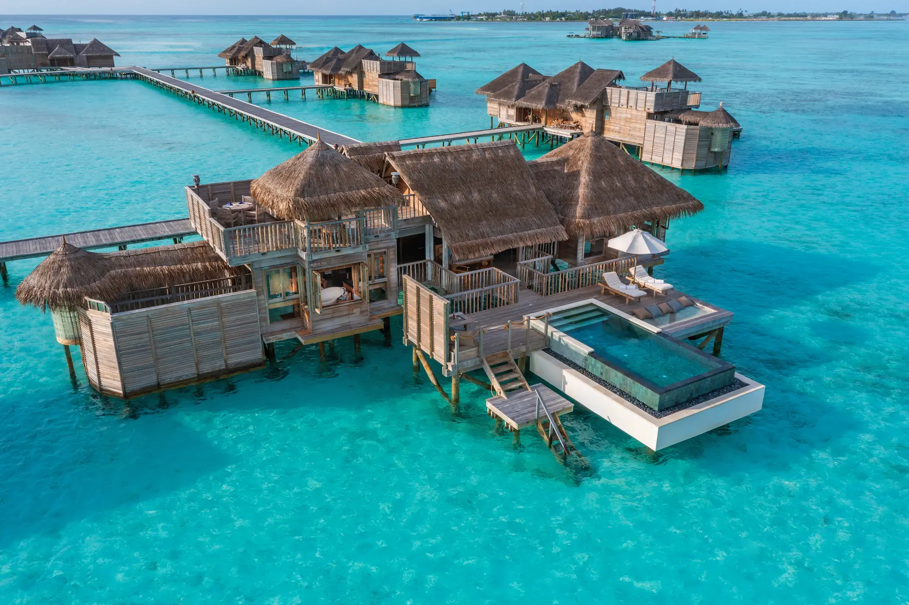 an elevated view of the villa suite with pool at gili lankanfushi maldives showcasing bright turquoise waters and relaxed overwater living