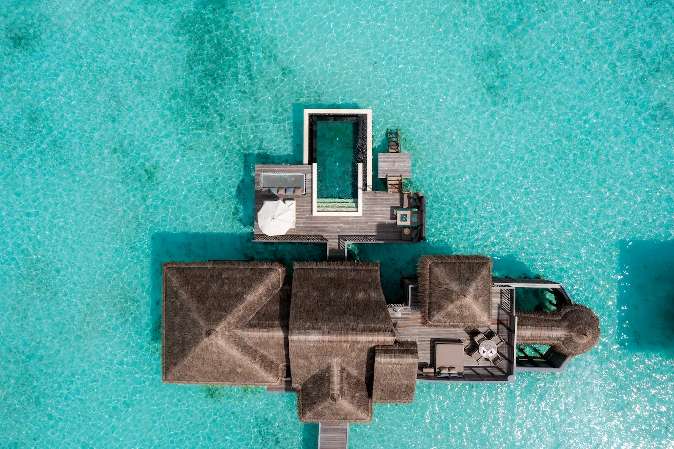 a bright elevated perspective of the villa suite with pool at gili lankanfushi maldives highlighting its tranquil overwater setting