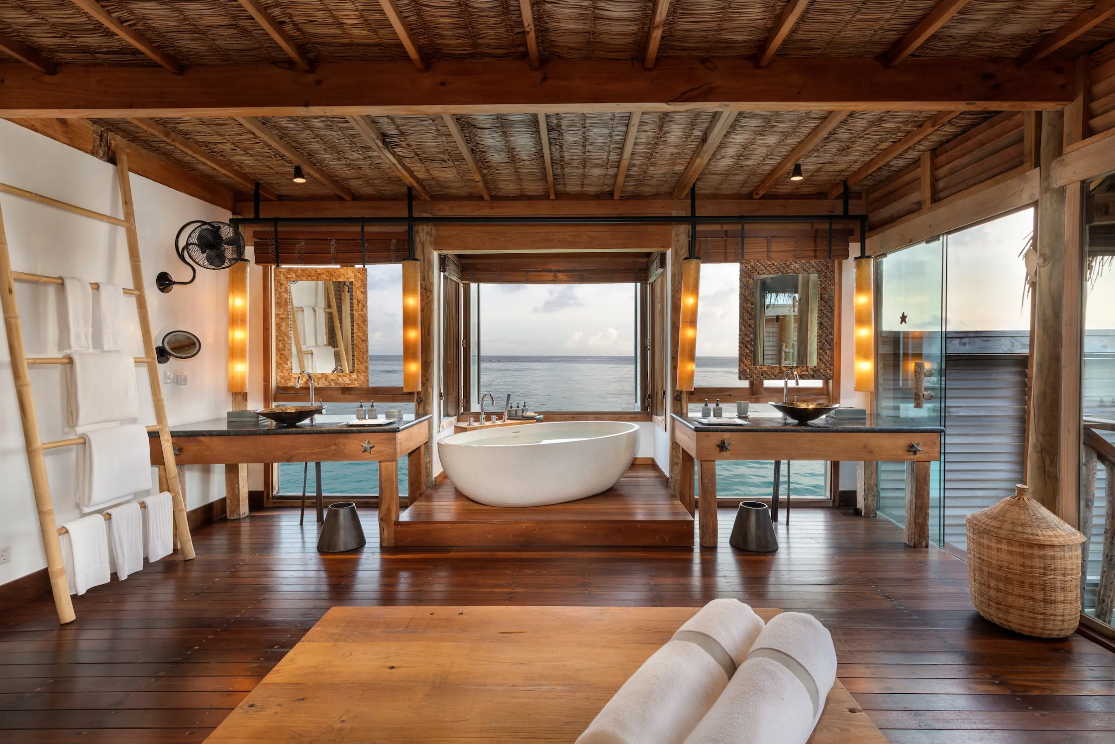 a calming overwater villa suite with pool bathroom at gili lankanfushi maldives featuring natural textures and serene ocean ambience