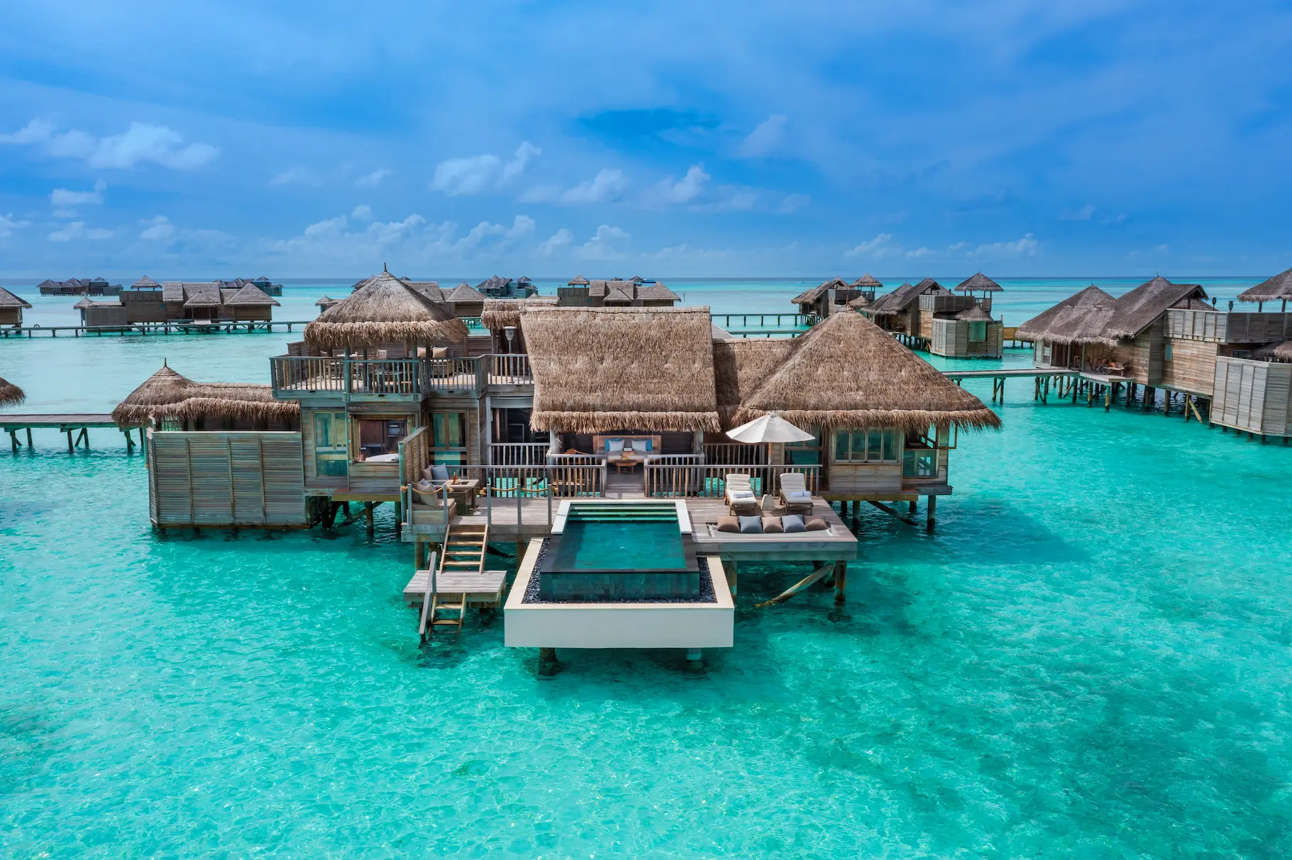 an inviting overwater villa suite with pool exterior at gili lankanfushi maldives set above clear turquoise lagoon waters
