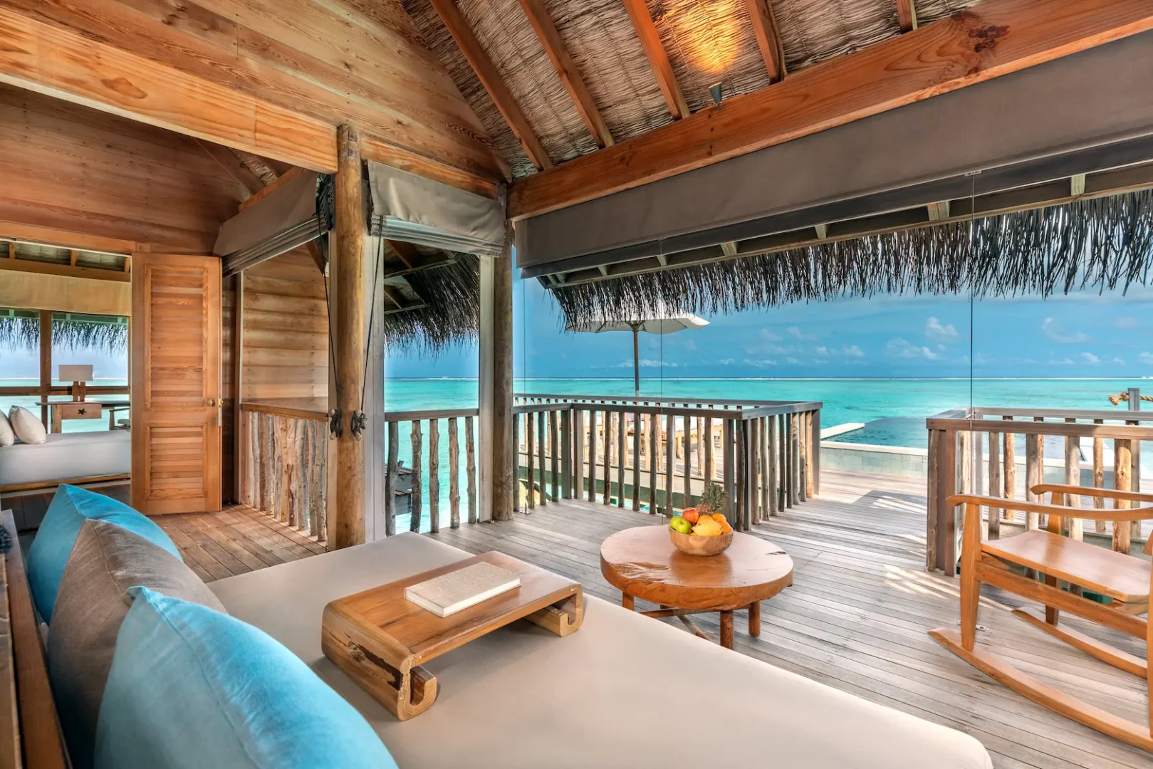 a spacious overwater villa suite with pool living room at gili lankanfushi maldives featuring natural textures and open lagoon views