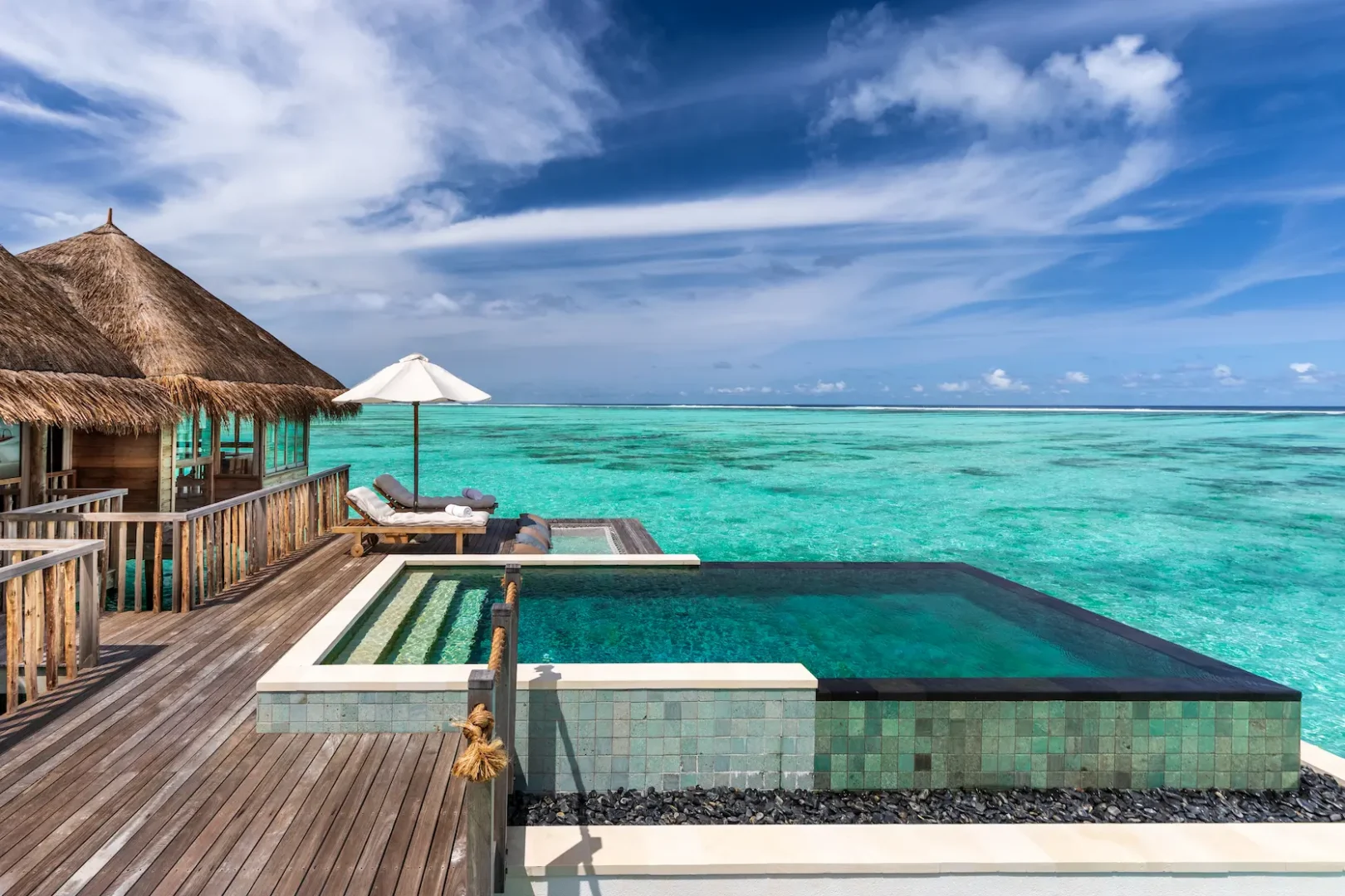 a peaceful overwater villa suite with pool terrace at gili lankanfushi maldives offering calm ocean facing views