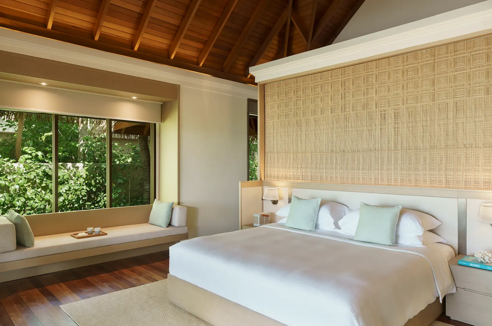 heritance aarah maldives deluxe beach bungalow bed featuring an elegant beachfront sleeping space with soft island light and refined tropical comfort