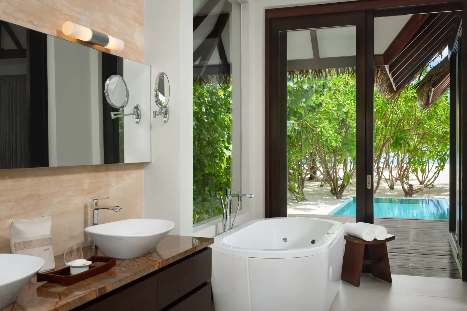 heritance aarah maldives family beach pool villa bathroom featuring elegant natural textures and a serene spa inspired ambience